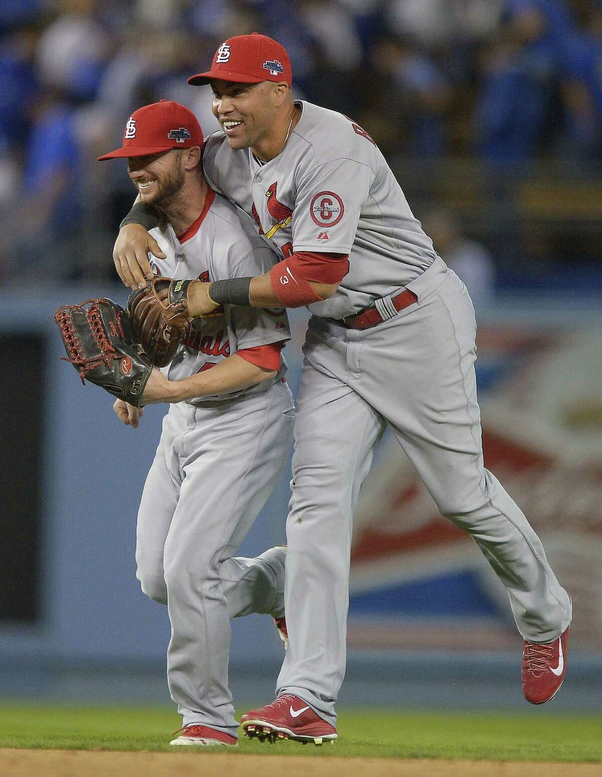 Shane Robinson (left), who had a solo home run in the seventh inning, and Carlos Beltran celebrate after the Cardinals took a 3-1 lead in the NLCS.