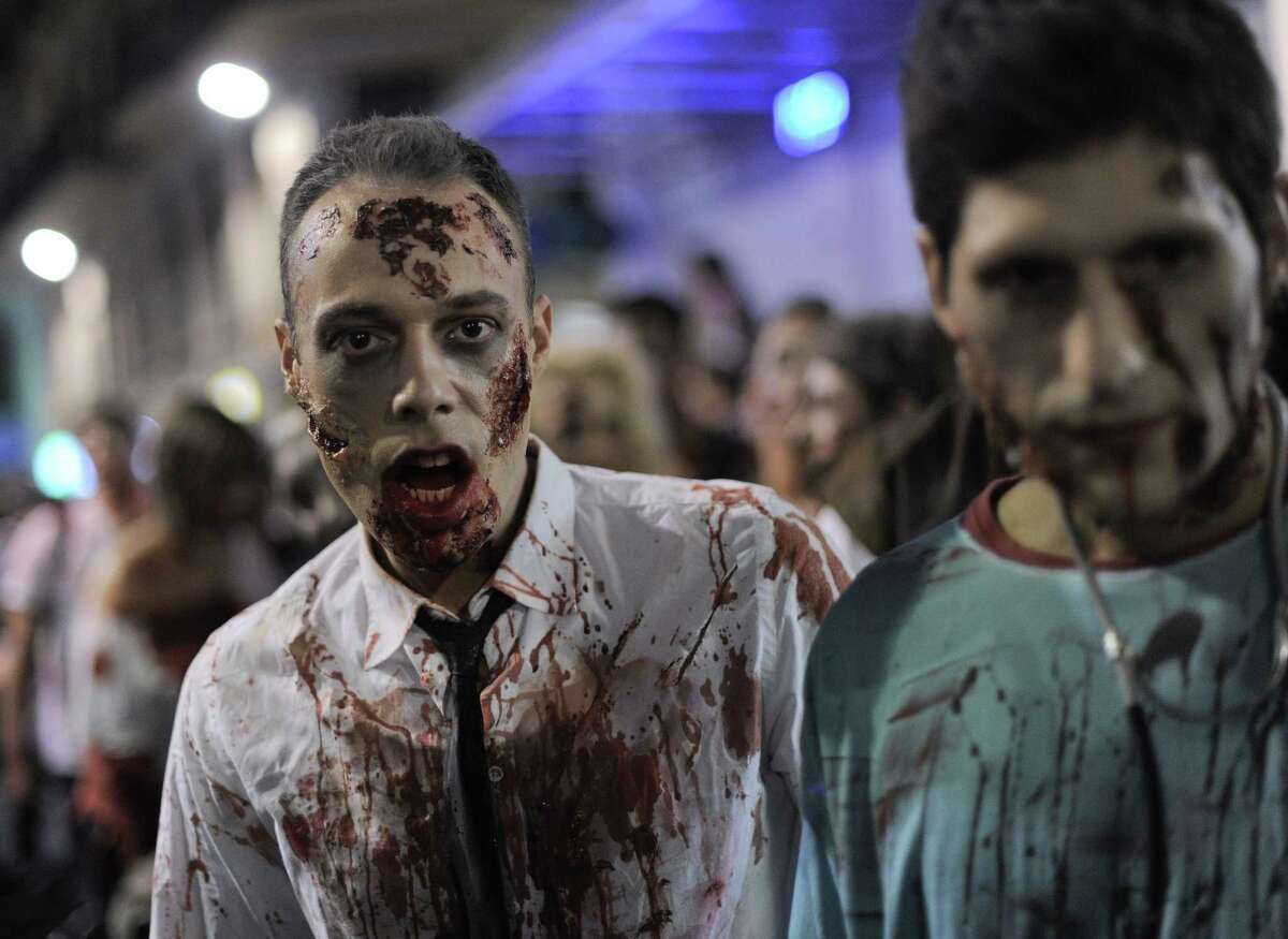 People dressed as zombies take part in a Zombie Walk in Sitges, near Barcelona, on October 12, 2013. AFP PHOTO/ JOSEP LAGOJOSEP LAGO/AFP/Getty Images