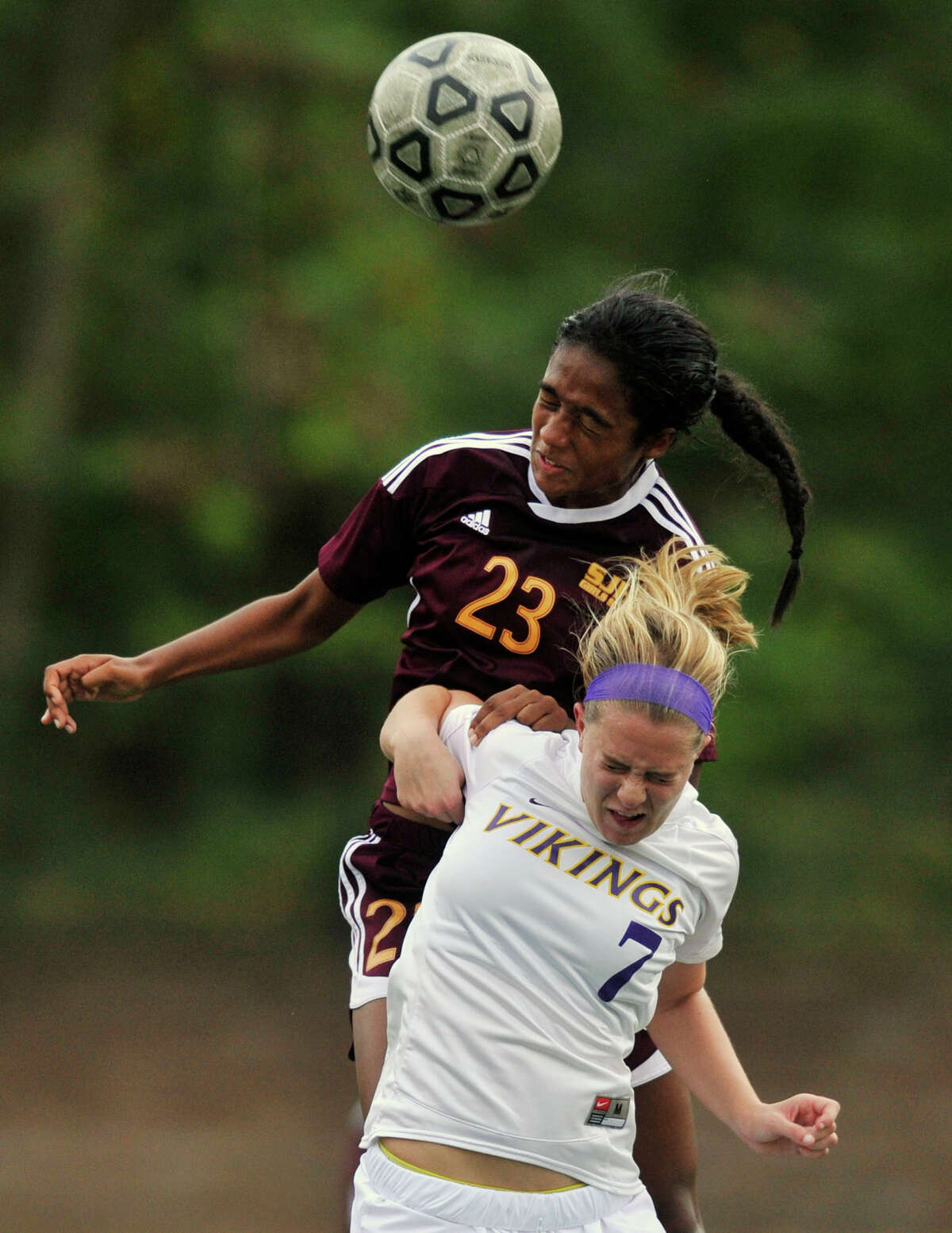 St. Joseph's Leah Lewis leaps over Westhill's Rachel Benz to get a head on the ball during their game at Westhill High School in Stamford, Conn., on Wednesday, Oct. 16, 2013. St. Joseph won, 4-1.