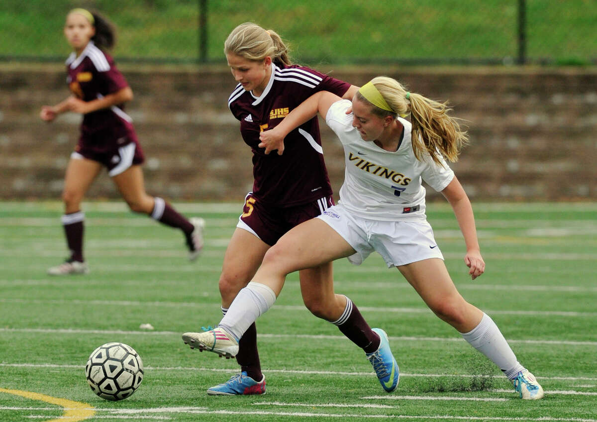 St. Joseph's Julia Marino battles Westhill's Rachel Benz for control of the ball during their game at Westhill High School in Stamford, Conn., on Wednesday, Oct. 16, 2013. St. Joseph won, 4-1.
