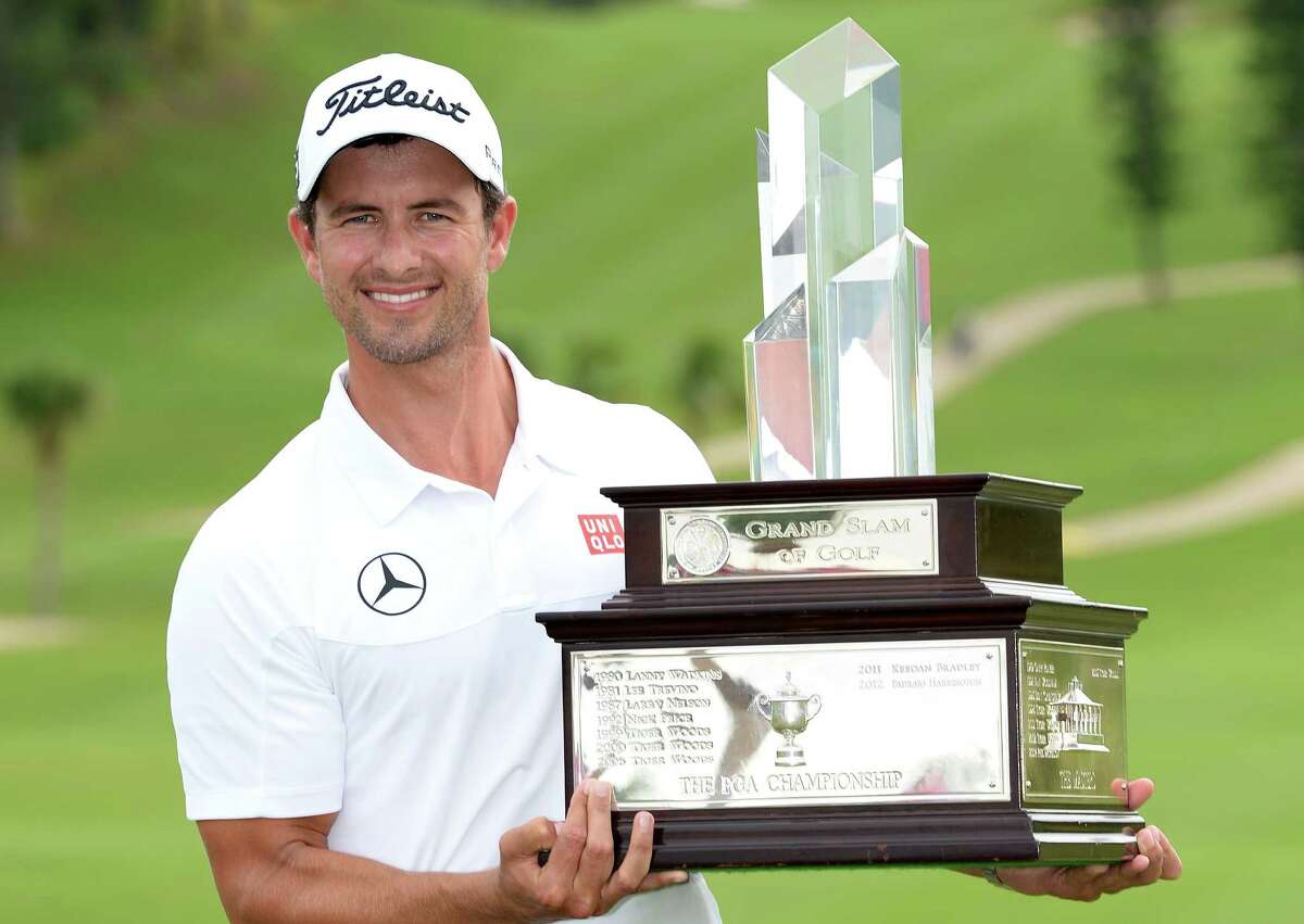 SOUTHAMPTON, BERMUDA - OCTOBER 16: Adam Scott of Australia with the winners trophy after the final round of the PGA Grand Slam of Golf at Port Royal Golf Course on October 16, 2013 in Southampton, Bermuda. (Photo by Ross Kinnaird/Getty Images)