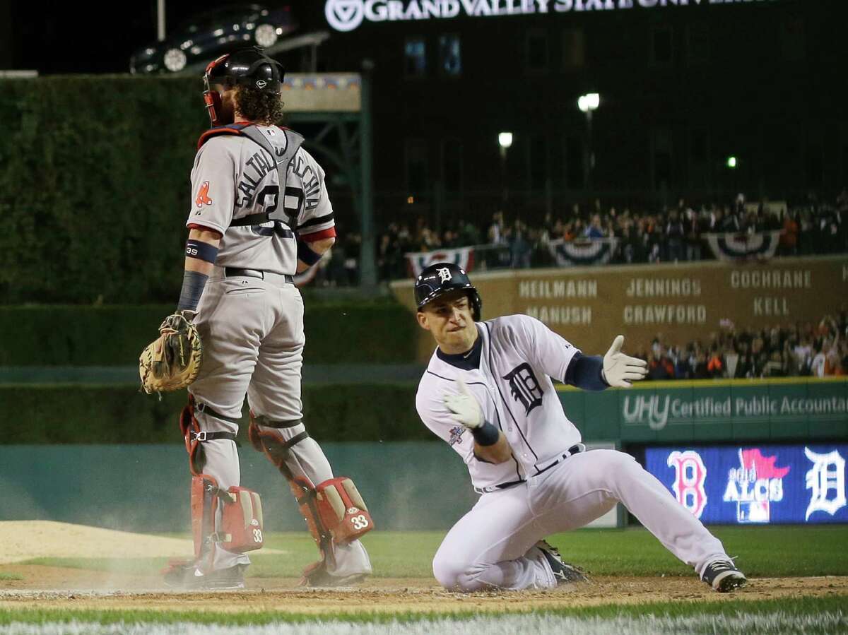 Jose Iglesias slides home with the Tigers' fourth run, scoring on a two-run double by Torii Hunter.