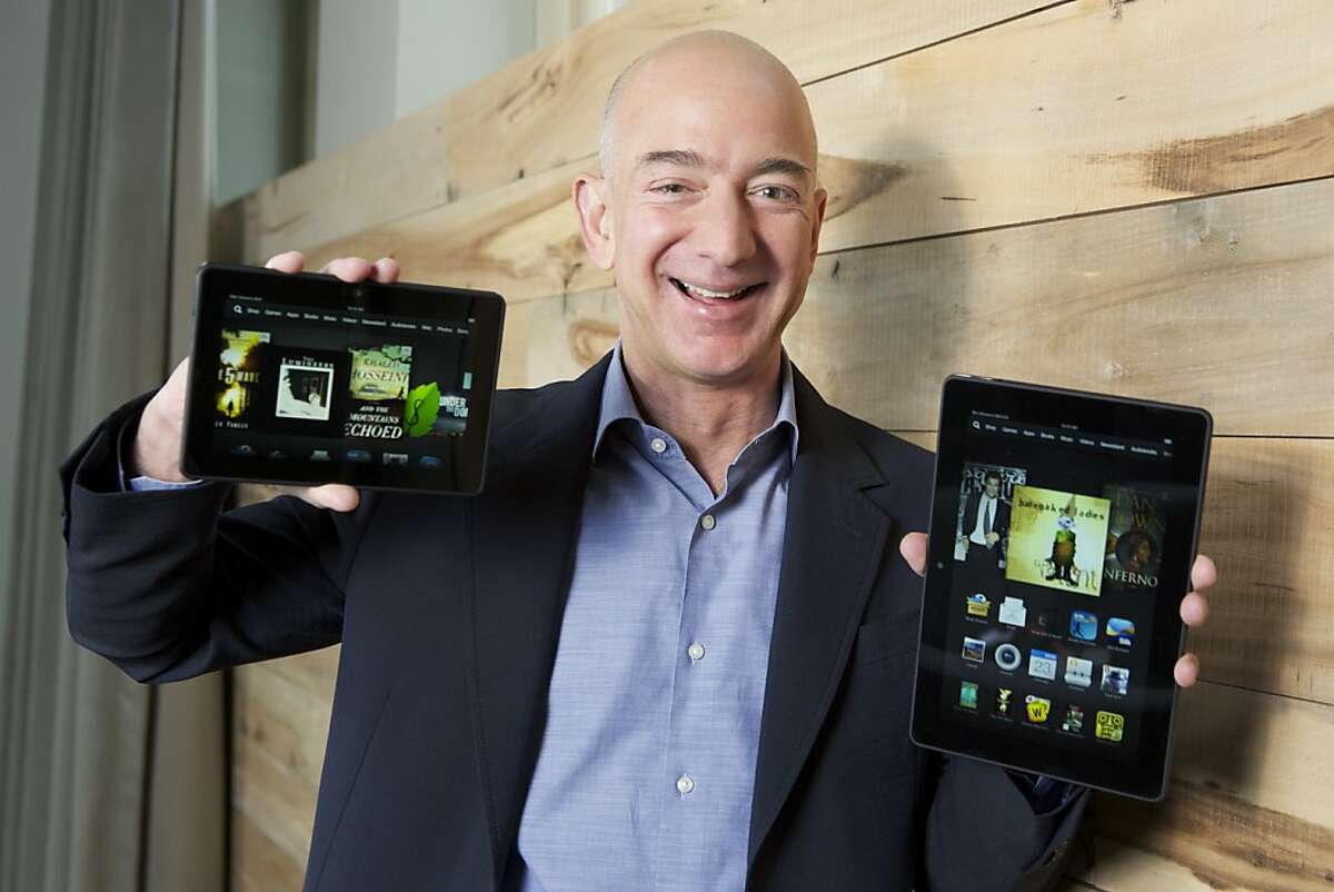 IMAGE DISTRIBUTED FOR AMAZON – In this image distributed on Tuesday, Sept. 24, 2013, Amazon.com Founder and CEO Jeff Bezos introduces the all-new Kindle Fire HDX 8.9'', right, and Kindle Fire HDX 7'' tablet in Seattle."