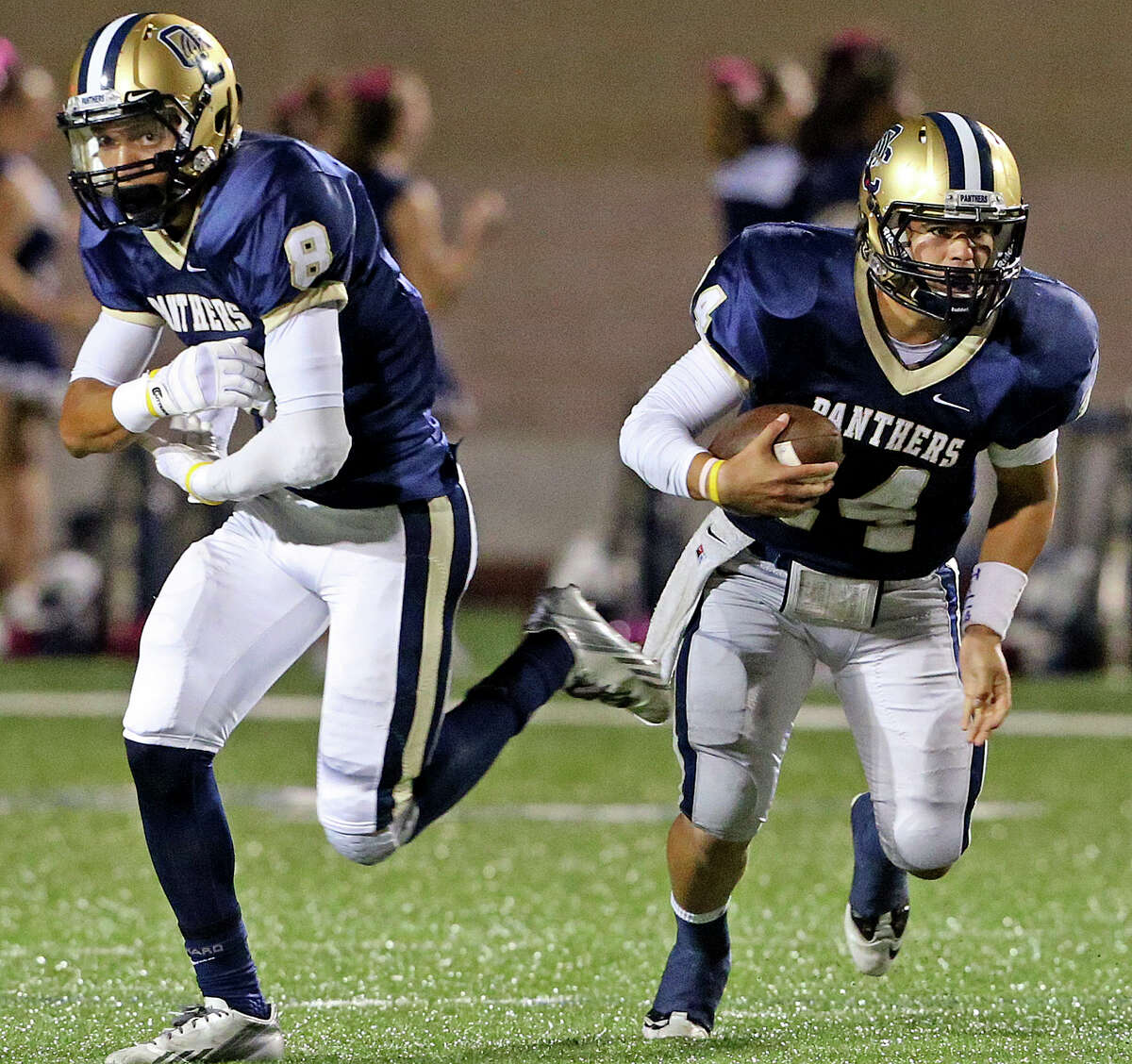 O'Connor quarterback Zach Galindo takes off with the ball after faking to Alonso Roscoe as Warren plays O'Connor at Farris Stadium on October 18, 2013.