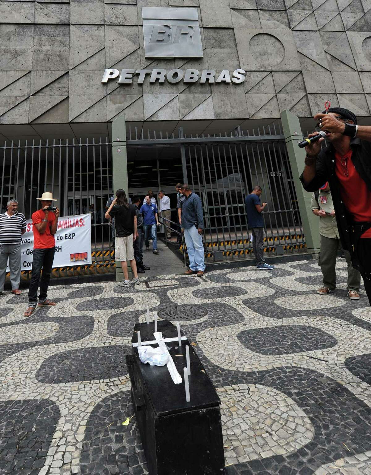 Oil industry workers demonstrate against a pre-salt auction for deepwater deposits at the huge Libra field, in front of Petrobras headquartes in Rio de Janeiro on October 17, 2013. Next October 21 sees Brazil's first pre-salt auction in six years for deepwater deposits at the huge Libra field in the southeastern Santos basin where recoverable reserves of some 12 billion barrels could see production of an estimated 1m barrels per day (bpd) in five years. AFP PHOTO/VANDERLEI ALMEIDAVANDERLEI ALMEIDA/AFP/Getty Images