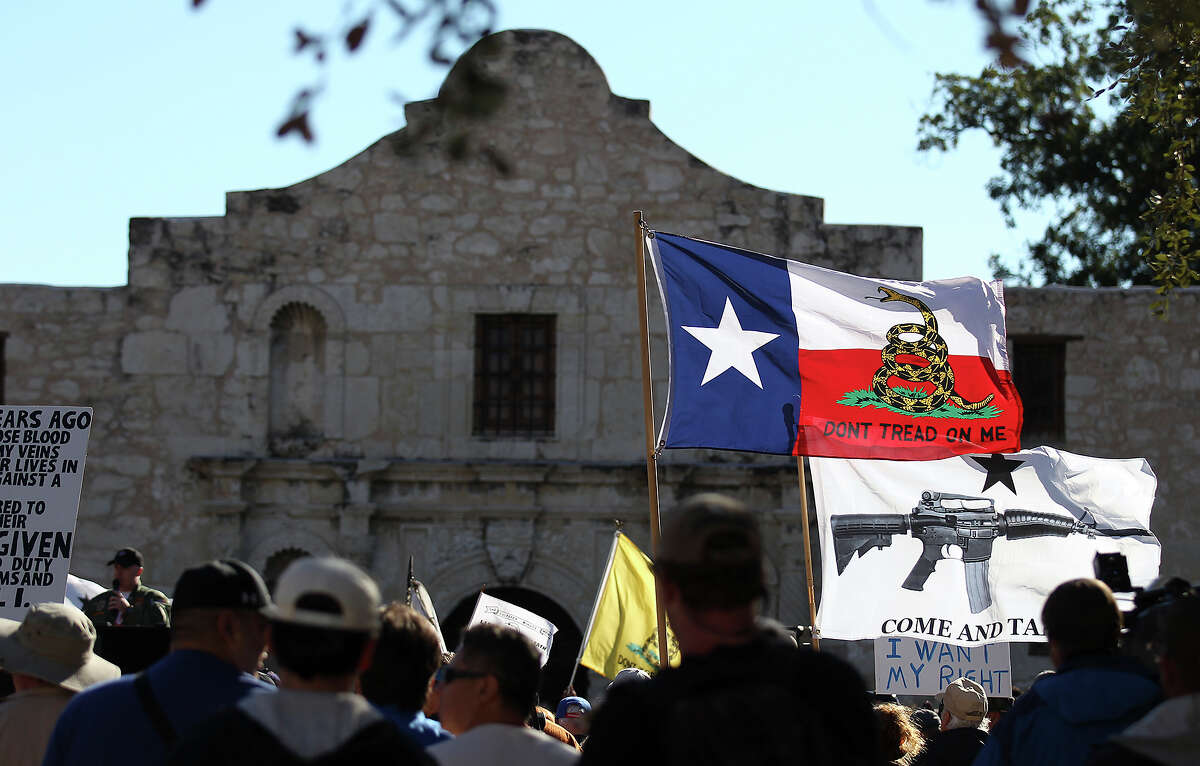 Flags fly at the Come And Take It San Antonio pro-gun rally on Saturday, Oct. 19, 2013. Several hundred pro-gun owners displayed their rifles and long arms at a rally on the grounds of the Alamo. The group later marched to Travis Park where the event concluded.