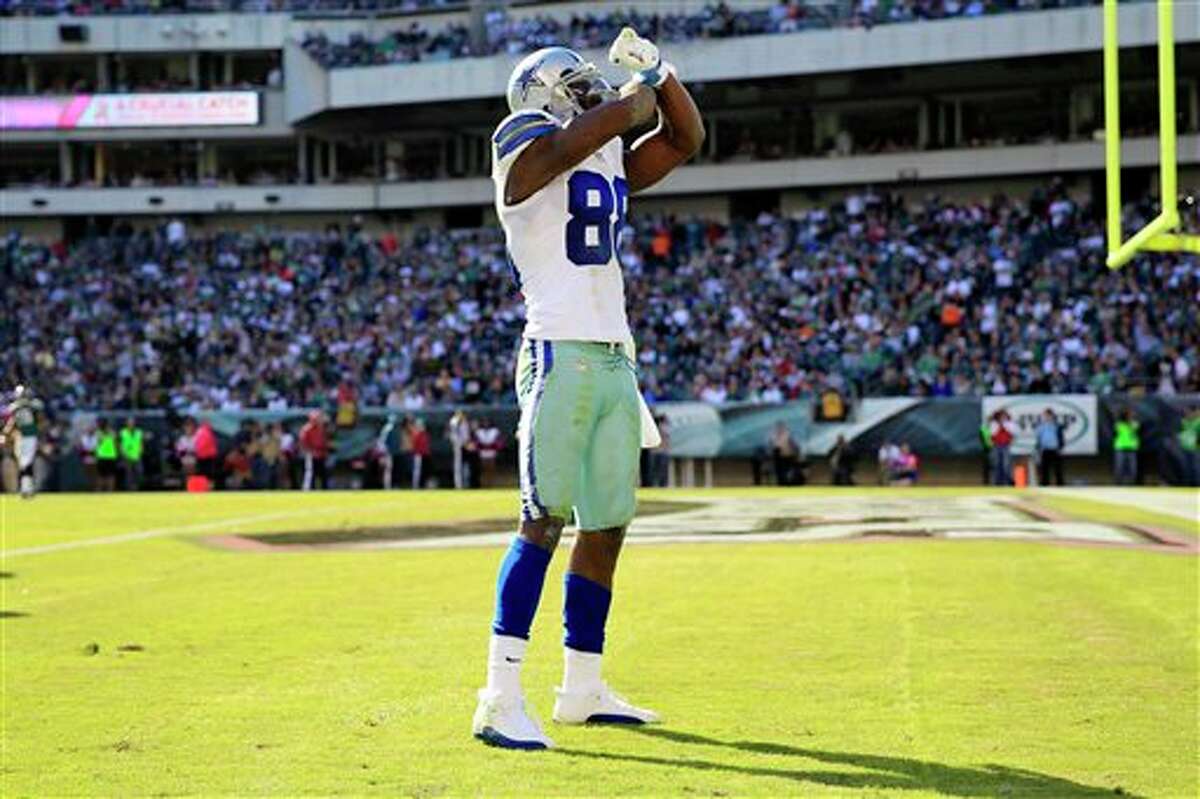 Dallas Cowboys wide receiver Dez Bryant gestures after catching a pass to put the Cowboys inside the Philadelphia Eagles 5-yard line during the first half of an NFL football game, Sunday, Oct. 20, 2013, in Philadelphia.