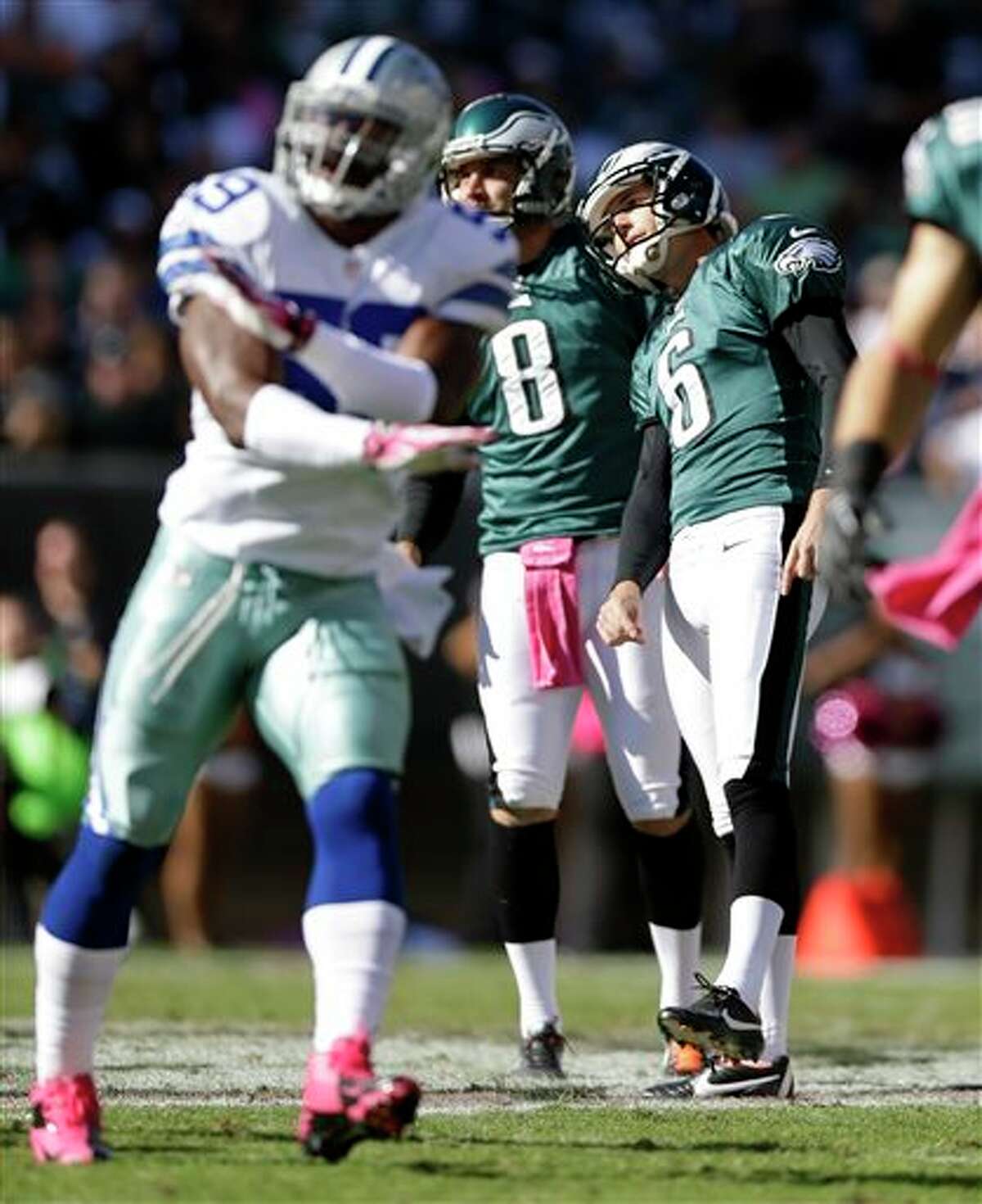 Philadelphia Eagles kicker Alex Henery (6) and placeholder Donnie Jones (8) watch Henery's missed field goal attempt as Dallas Cowboys' Ernie Sims, left, gestures against it during the first half of an NFL football game, Sunday, Oct. 20, 2013, in Philadelphia.