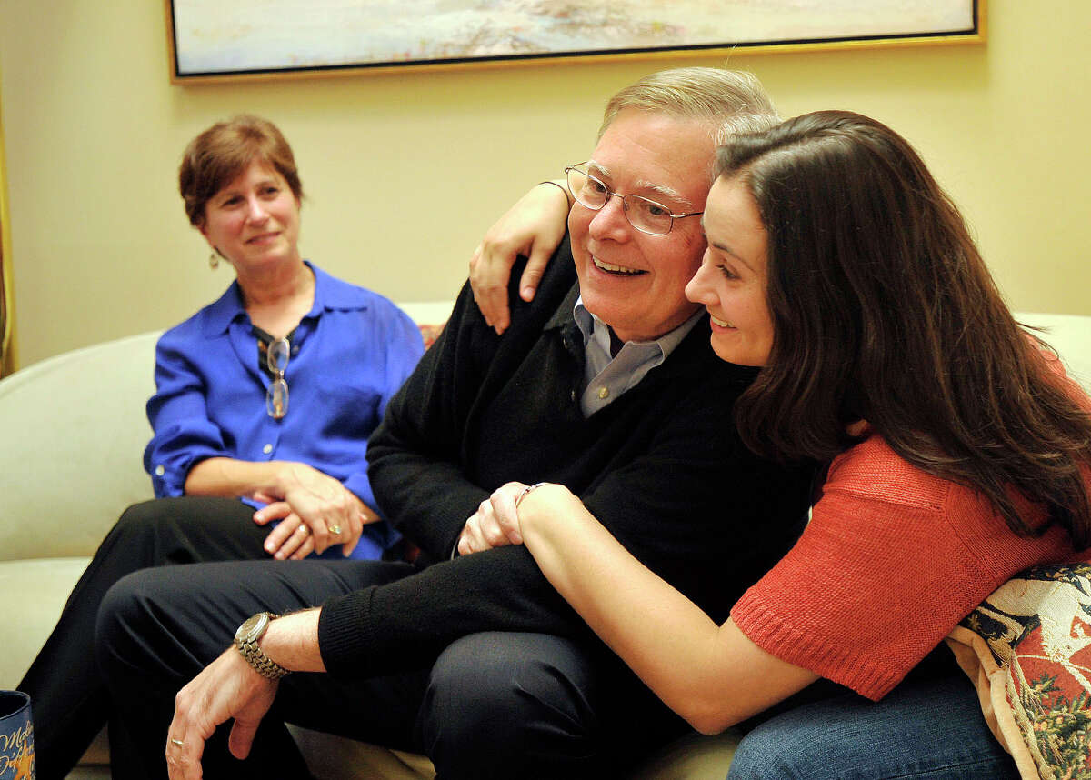 Democratic mayoral candidate David Martin and his daughter, Sarah, embrace as his wife, Judy, looks on while speaking to a reporter at their home in north Stamford on Monday, Oct. 21, 2013.