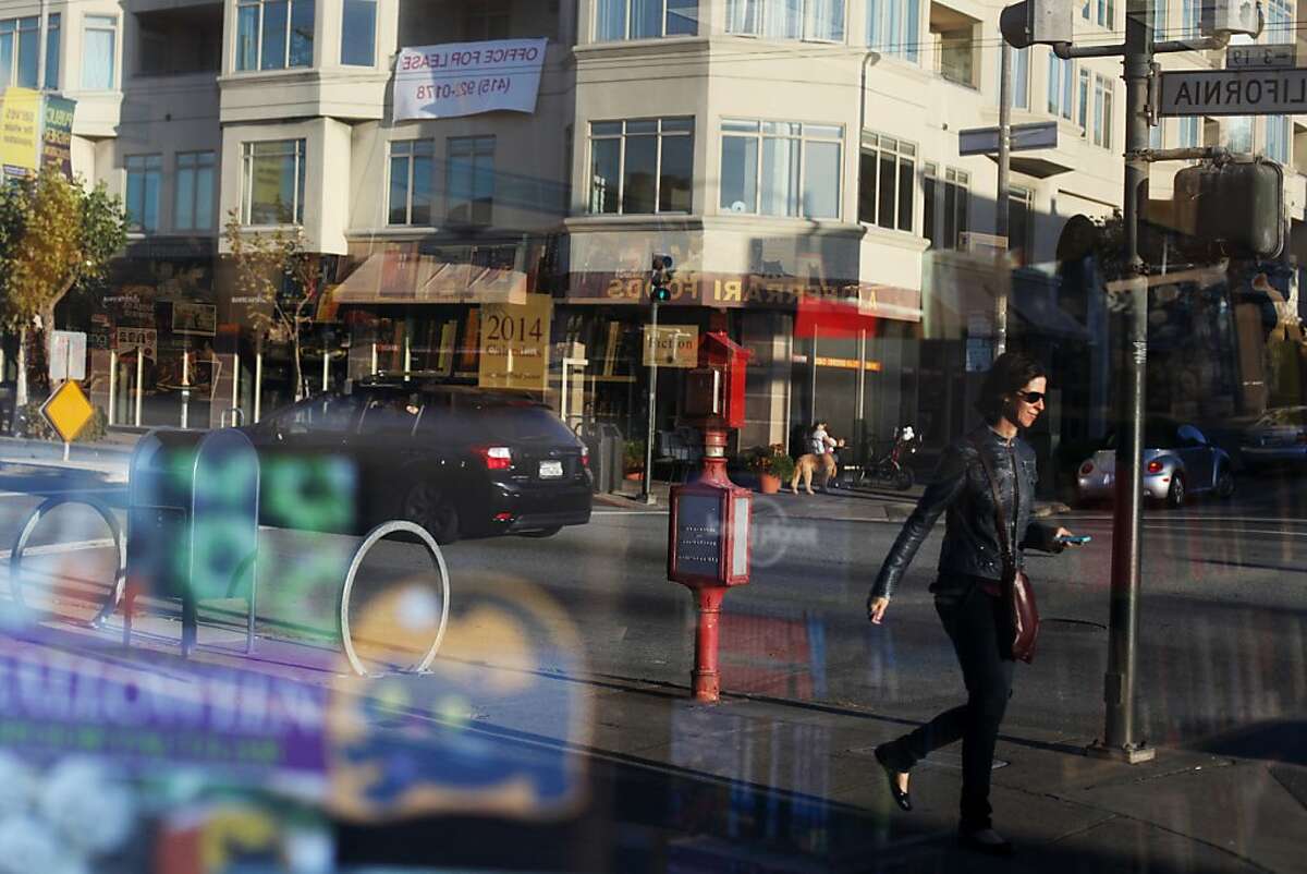 A pedestrian is reflected in the window of Books, Inc. on October 19, 2013 in the Laurel Heights area of San Francisco, Calif.