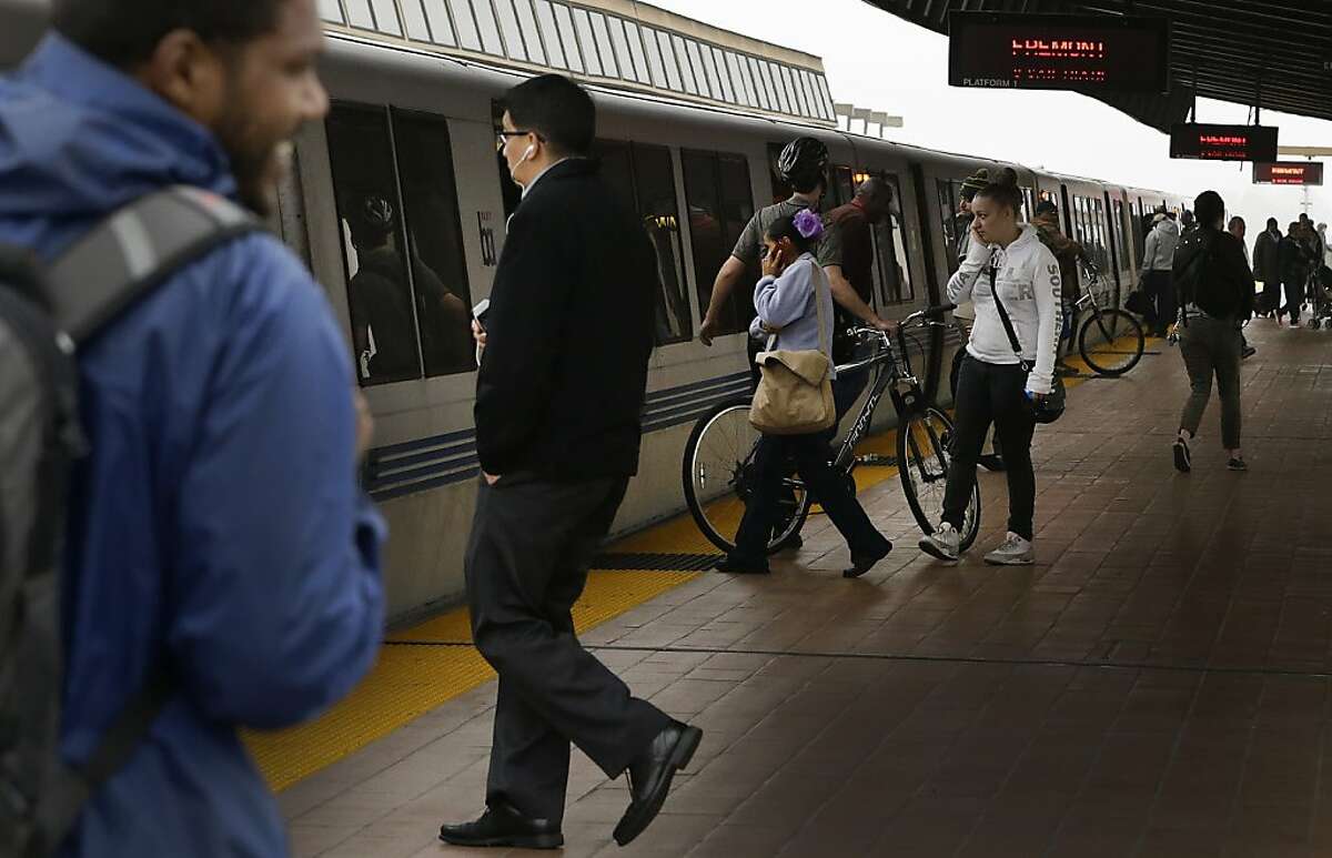 Bay Area Rapid Transit passengers board a BART train Tuesday, Oct. 22, 2013, in Oakland.
