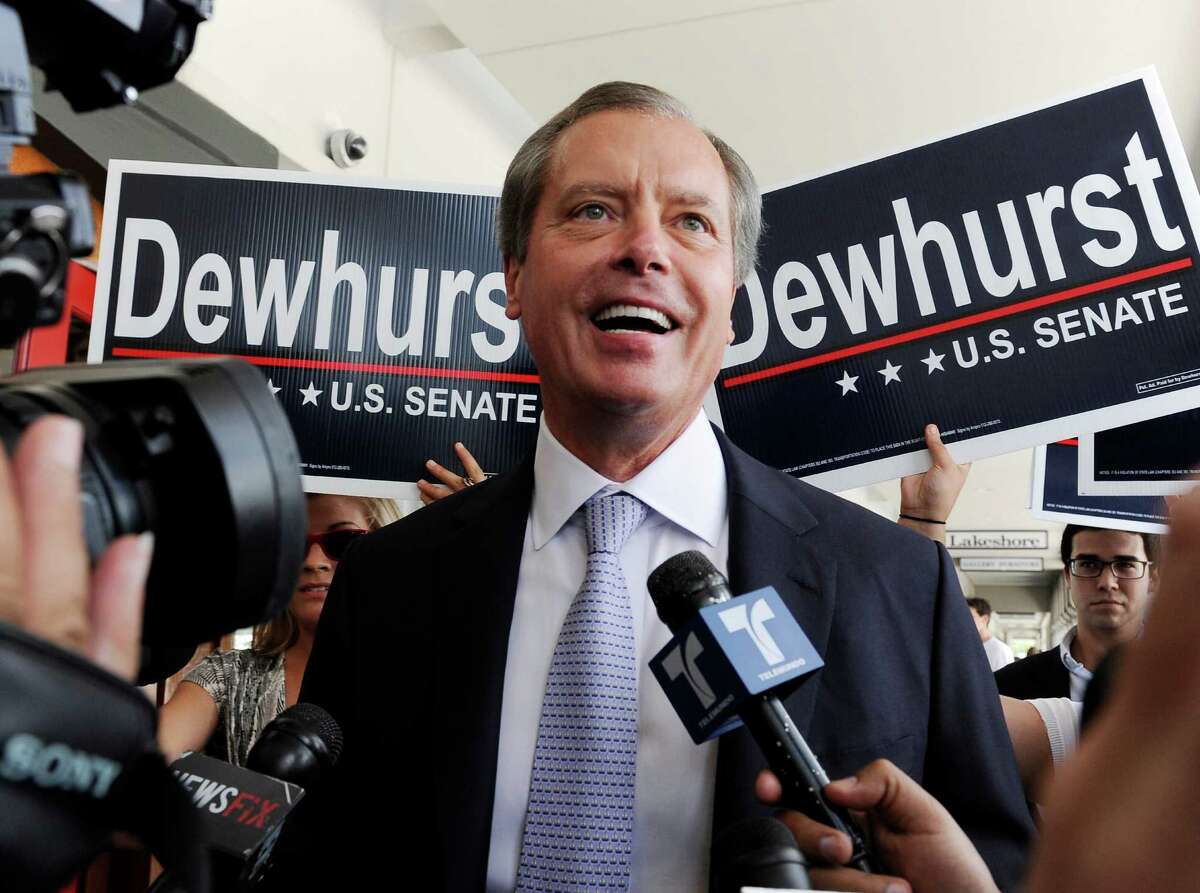 In a July 31, 2012 file photo, Texas Lt. Gov. David Dewhurst is backed by supporters outside a Houston during the Republican primary runoff campaign for U.S. Senator. Dewhurst said Tuesday, Aug. 28, 2012 that he will run for a fourth term in 2014 following his failed bid for the U.S. Senate.(AP Photo/Pat Sullivan, File)