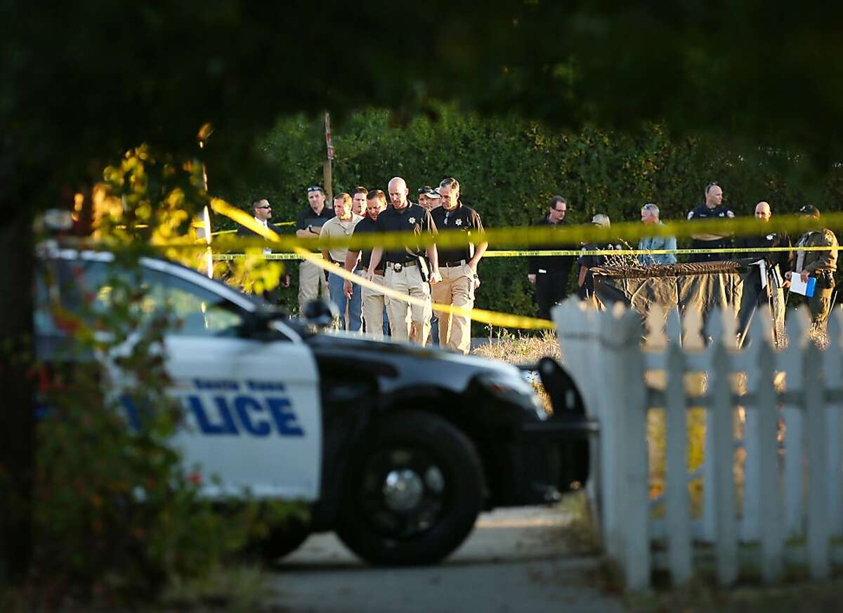 In this photo taken Tuesday Oct. 22, 2013, law enforcement investigators look over the body of a 13-year-old boy shot and killed by officers in Santa Rosa, Calif. Two California sheriff's deputies saw the boy walking with what appeared to be a high-powered weapon Tuesday, sheriff's Lt. Dennis O'Leary said. The replica gun resembled an AK-47, according to a photograph released by the sheriff's office. Deputies learned after the shooting that it wasn't an actual firearm, according to O'Leary. The teen was pronounced dead at the scene. The deputies, who have not been identified, have been placed on administrative leave, which is standard after a shooting, O'Leary said.