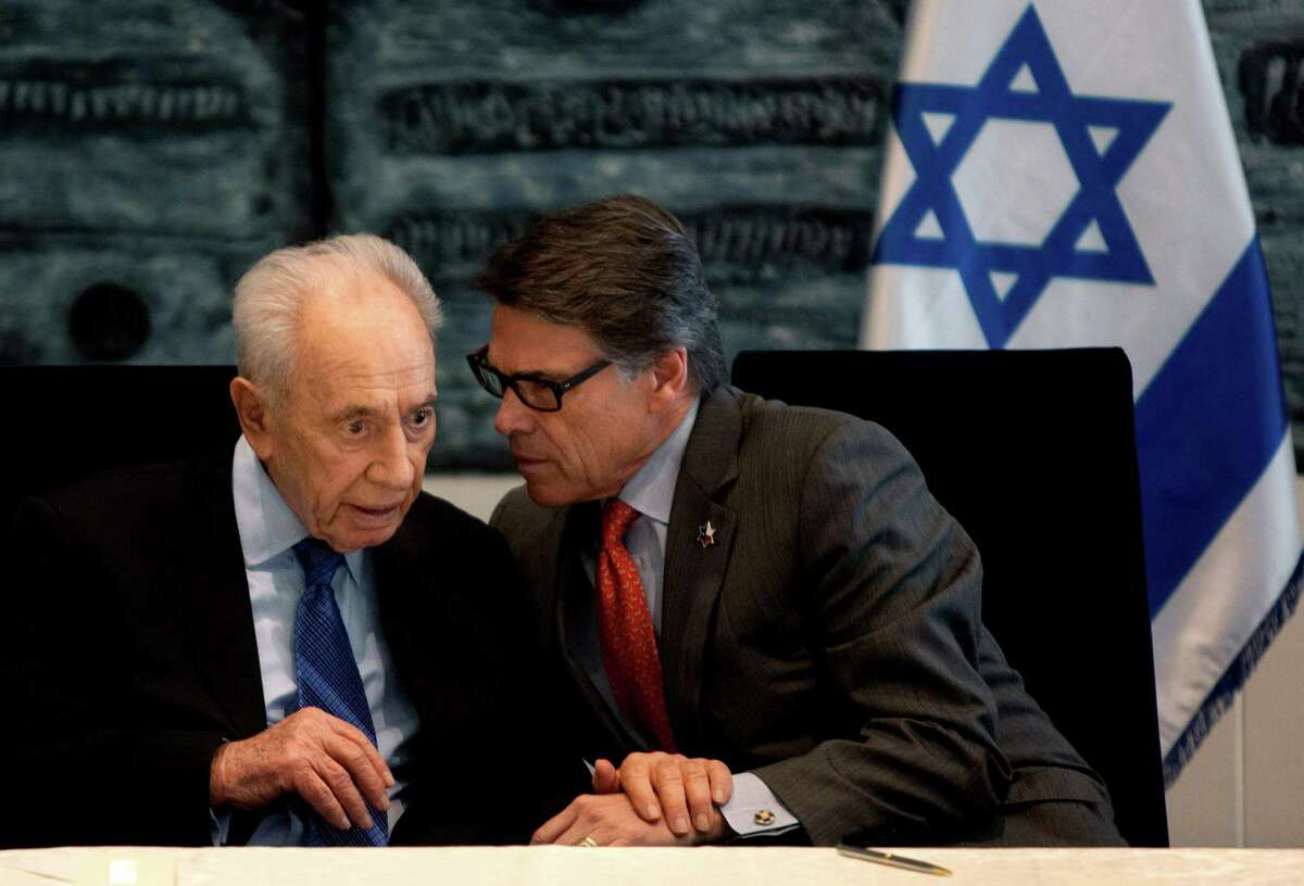Israel's President Shimon Peres, left, and Texas Gov. Rick Perry, speak during a ceremony in the President's residence in Jerusalem, Wednesday, Oct. 23, 2013. Texas A&M University said it plans on opening a branch campus in Israel, a first-of-its-kind project that will expand the American university’s growing overseas presence. (AP Photo/Sebastian Scheiner)