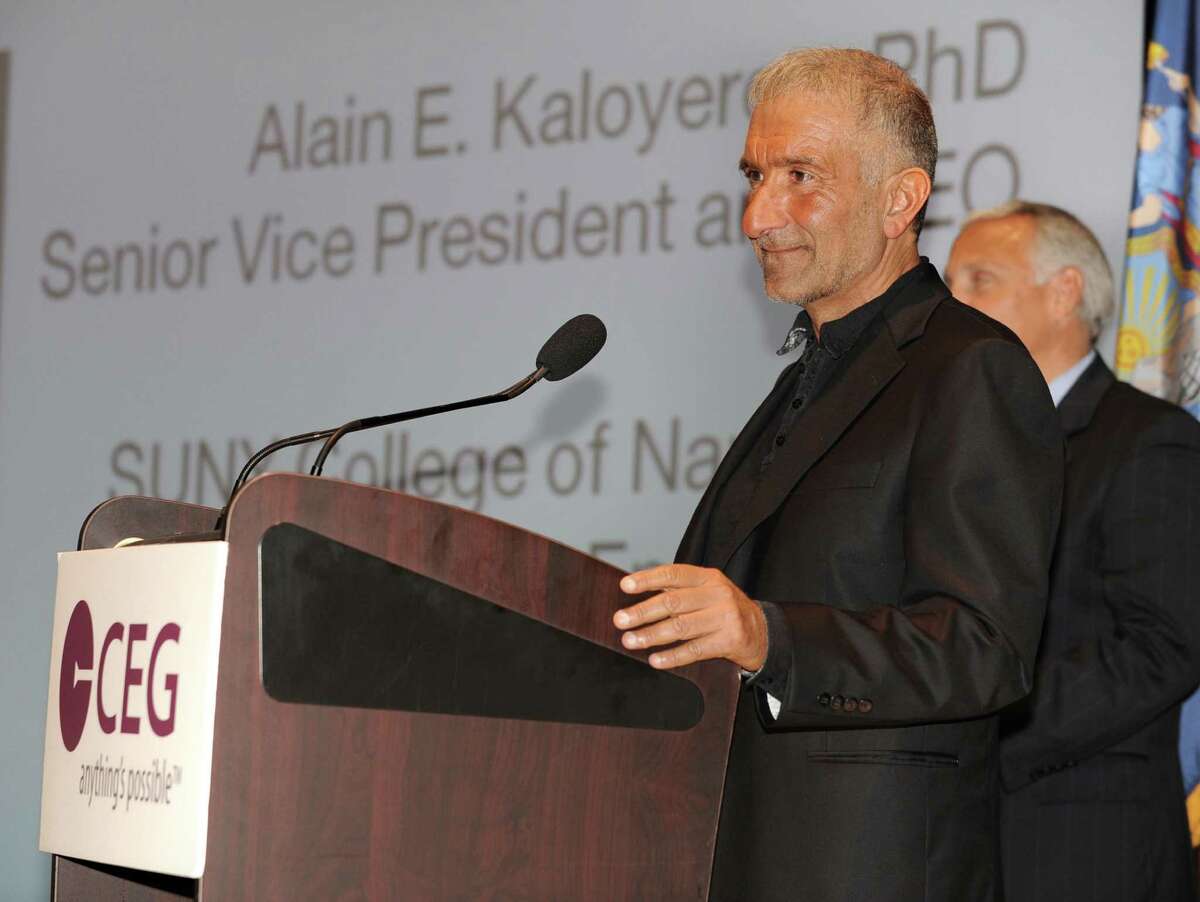 Alain Kaloyeros, Senior Vice President and Chief Executive Officer for CNSE at University At Albany, delivers the keynote speech at the annual meeting of the Center for Economic Growth at Kiernan Plaza on Wednesday, Oct. 23, 2013 in Albany, N.Y. CNSE Vice President for Marketing and Communications Steve Janack listens in the background. (Lori Van Buren / Times Union)