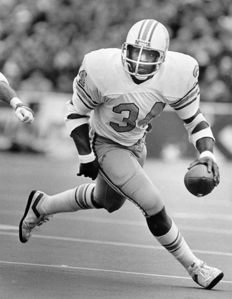 Former NFL great Warren Moon poses with his bust after