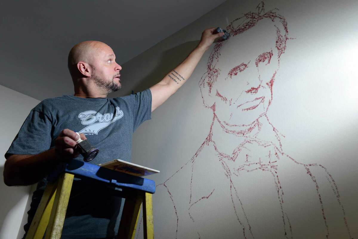 Artist Roberto Martinez creates the image of Abraham Lincoln out of time stamps in the vault on the third floor of McLevy Hall in downtown Bridgeport, Conn. The historic building will become a new home for artists beginning on Nov. 7 thanks to a state-city grant-funded partnership that will provide space for artists to create and sell their artwork from inside the building.