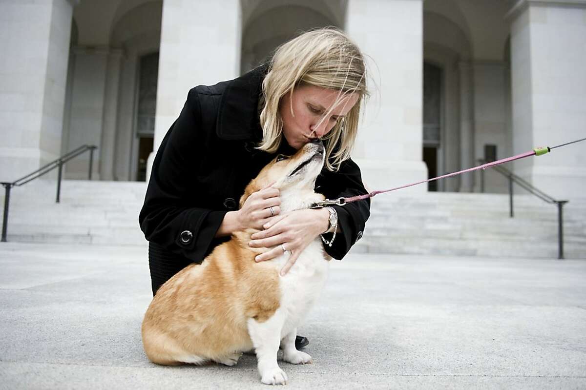 Jennifer Fearing, California Senior State Director of The Humane Society, kisses Sutter the Brown's dog in the East steps of the State Capitol. It's official Sutter the dog which has been hanging out with Gov. Jerry Brown and his wife Anne Gust Brown will be a permanent fixture of the family Gust Brown announced on Tuesday, Feb. 14, 2011.