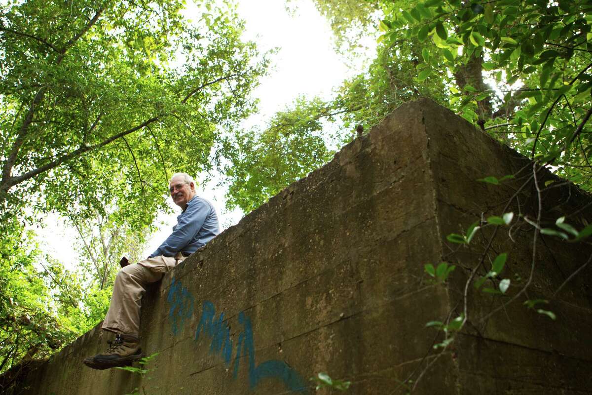 Louis Aulbach, Vicepresident of Houston Archeological Society sits on the ruins of what it used to be a wood bridge part of the military training area Camp Logan. The camp was closed in 1919. The Houston Archeological Society is working with the local government to make studies on the site. Monday, Oct. 21, 2013, in Houston. ( Marie D. De JesÃ©ºs / Houston Chronicle )