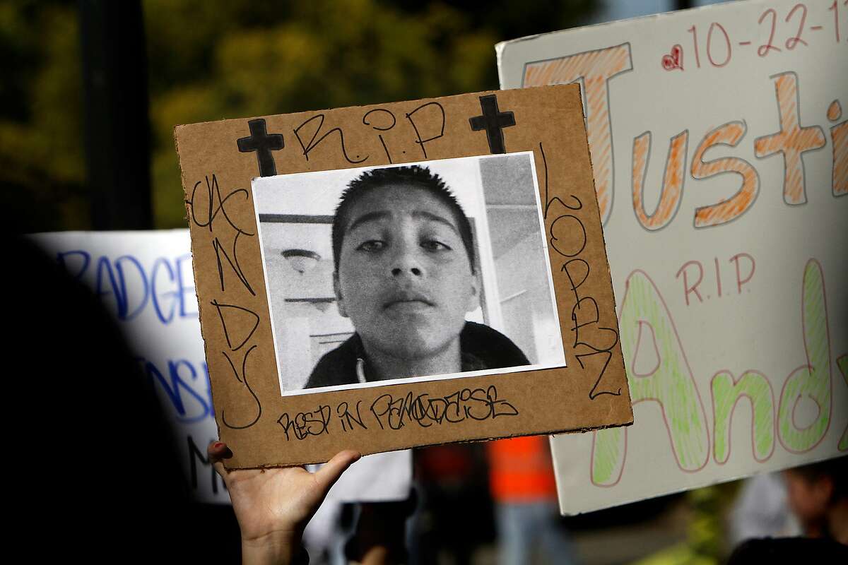 A protestor carries a photo of Andy Lopez Cruz, 13, on a march protesting his death in Santa Rosa, Calif., on Friday, October 25, 2013. The eighth-grader was killed by police while walking near his home carrying a toy rifle.