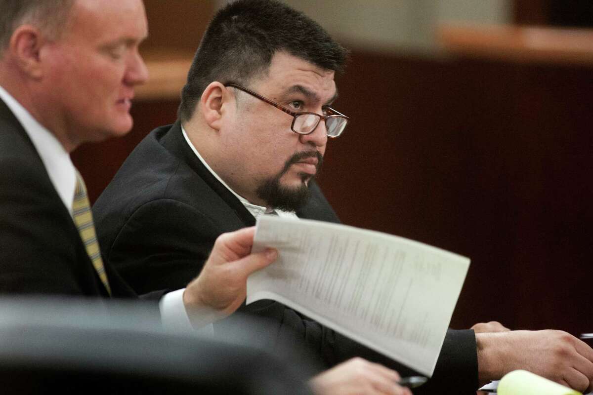 Defendant Jorge Amezquita sits in the courtroom with his attorney Danny Easterling,front, on Tuesday, May 28, 2013, in Houston. Amezquita is accused of killing Leo Gomez Sr. and his wife, Milagro Vanegas, both 53, during a home invasion June 24, 2008. ( J. Patric Schneider / For the Chronicle )