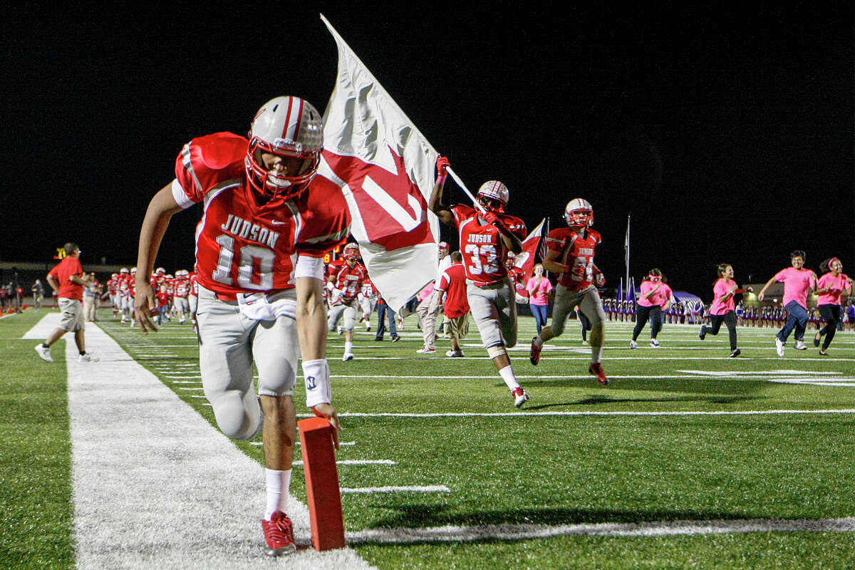 Judson's Rayjohn Austin-Ramsey (left) knocks down the pylon as the Rockets take a field, a long standing Rocket tradition, prior to the start of their game with San Marcos at Rutledge Stadium on Friday, Oct. 25, 2013. Judson won the game 72-18 and set a state record for consecutive winning seasons at 37 with the victory. MARVIN PFEIFFER/ mpfeiffer@express-news.net