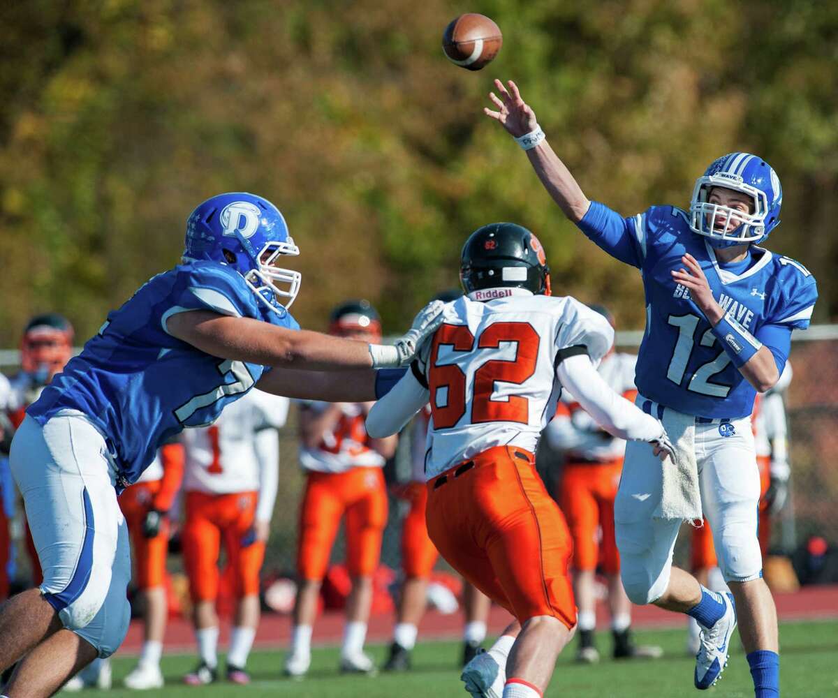 Darien high school quarterback Silas Wyper throws the ball downfield during a football game against Ridgefield high school played at Darien high school, Darien, CT on Saturday, October, 26th, 2013