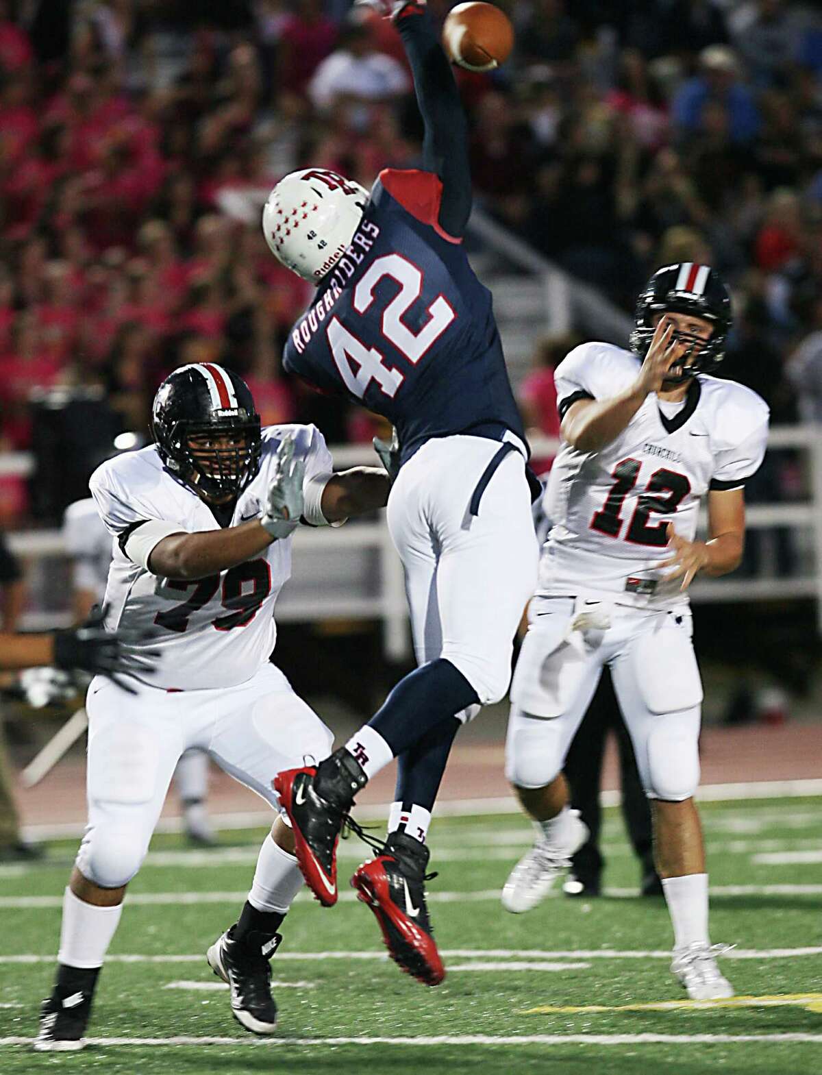 Roosevelt High Schoo's John Taylor tries to block a pass from Churchill's quarterback Nate Pearson as Churchill's Julian Casas pushes him from doing so Saturday, Oct. 26, 2013 at Comalander Stadium.