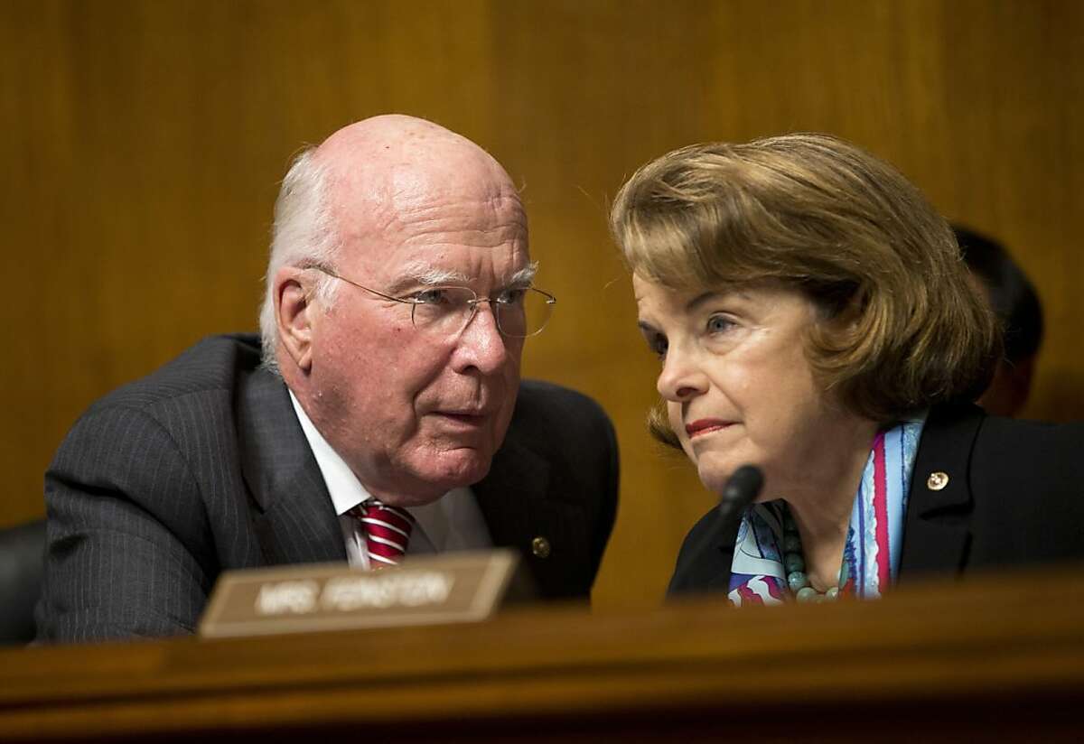 Senate Judiciary Committee Chairman Sen. Patrick Leahy, D-Vt., left, talks with Sen. Dianne Feinstein, D-Calif., on Capitol Hill in Washington, Wednesday, Oct. 2, 2013, during the committee's oversight hearing on the Foreign Intelligence Surveillance Act. U.S. intelligence officials say the government shutdown is seriously damaging the intelligence community's ability to guard against threats. (AP Photo/ Evan Vucci)