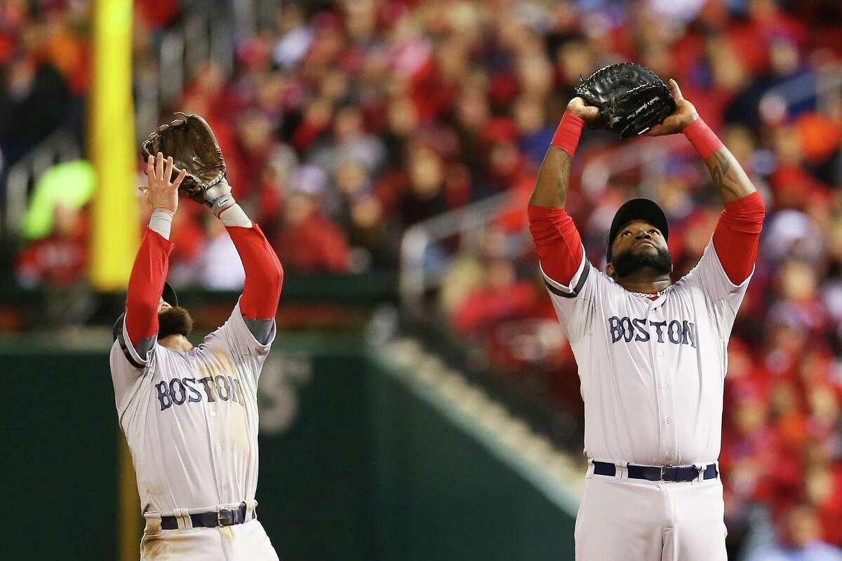 Boston's Dustin Pedroia (left) and David Ortiz look to catch a fly ball during Sunday night's Game 4 of the World Series. Ortiz had three hits, including a double, and Pedroia had a hit and an RBI.