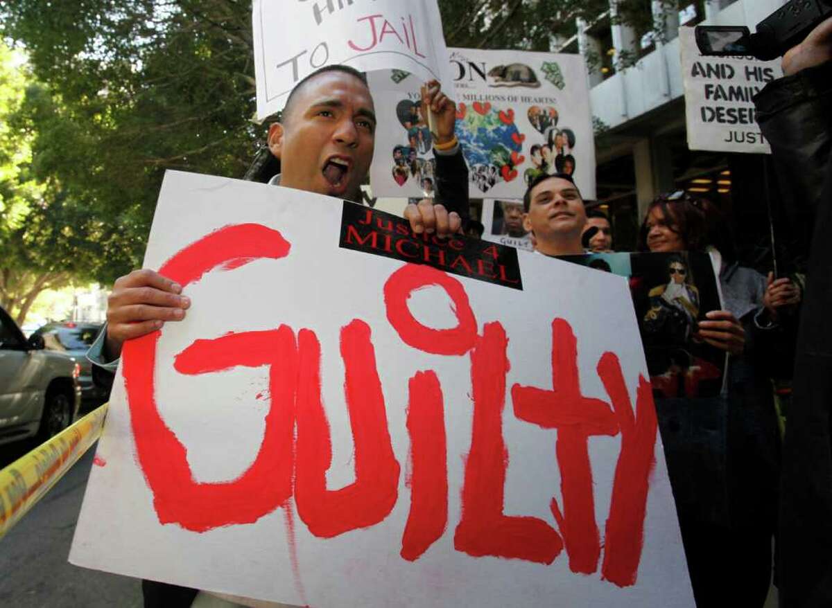 Michael Jackson supporter, Anthony Solis, screams for justice while holding a guilty sign on the sidewalk outside of the Clara Shortridge Foltz Criminal Justice Center, Monday, November 7, 2011, where jurors are deliberating the involuntary manslaughter charges against Dr. Conrad Murray.