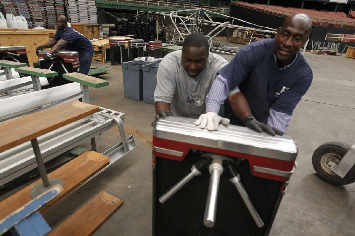 Astrodome workers sort through items and prepare for a "yard sale" that will open to the public Saturday morning. Seats, turf and other Dome items will be up for sale. (Johnny Hanson/Houston Chronicle)