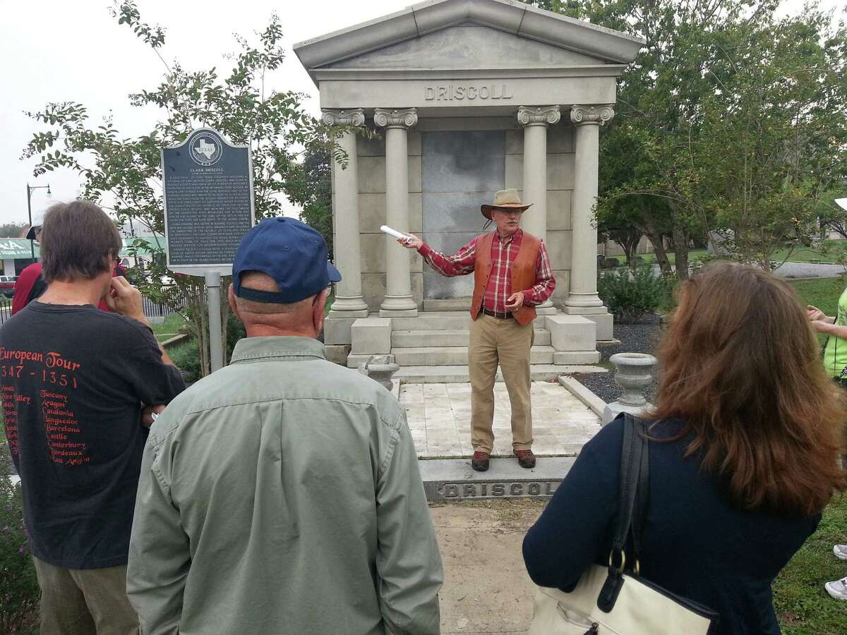 Wendall Fuqua, in front of the tomb of Clara Driscoll, takes questions from a group touring historic, East Side cemeteries through the Office of Historic Preservation.