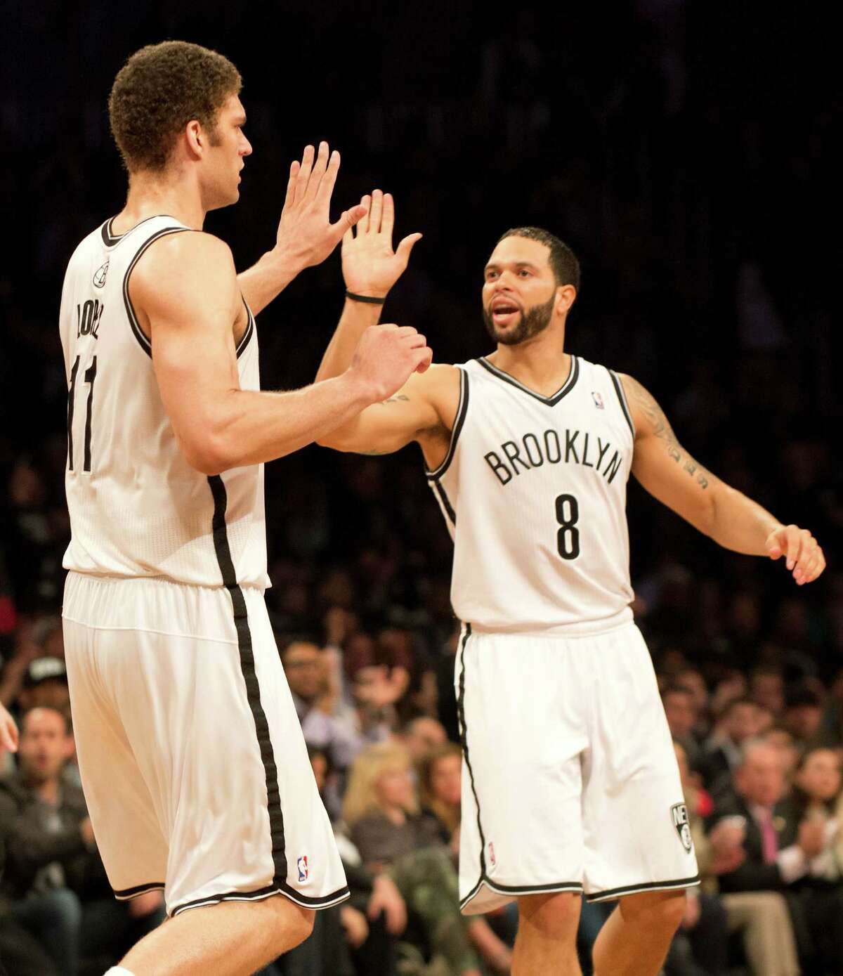 Brooklyn Nets Deron Williams (8) and Brook Lopez (11) celebrate against the Chicago Bulls during game five of their first round NBA playoff game April 29, 2013 at the Barclay Center in New York. AFP PHOTO/Don EmmertDON EMMERT/AFP/Getty Images