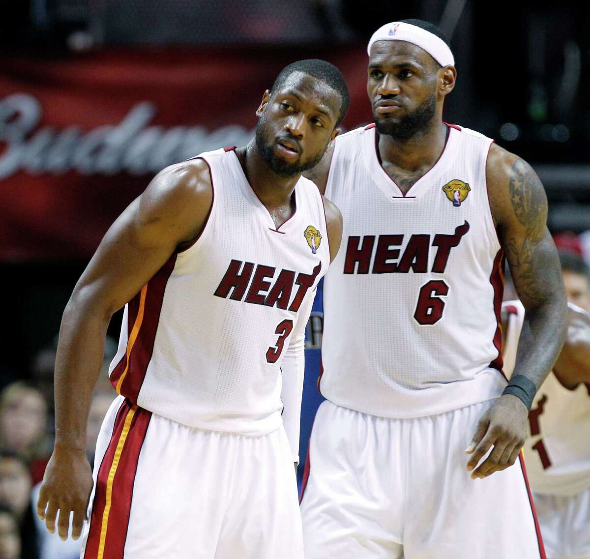 Miami Heat's Dwyane Wade (3) and LeBron James (6) reacts during the first half of Game 6 of the NBA Finals basketball game against the Dallas Mavericks Sunday, June 12, 2011, in Miami. (AP Photo/Lynne Sladky)