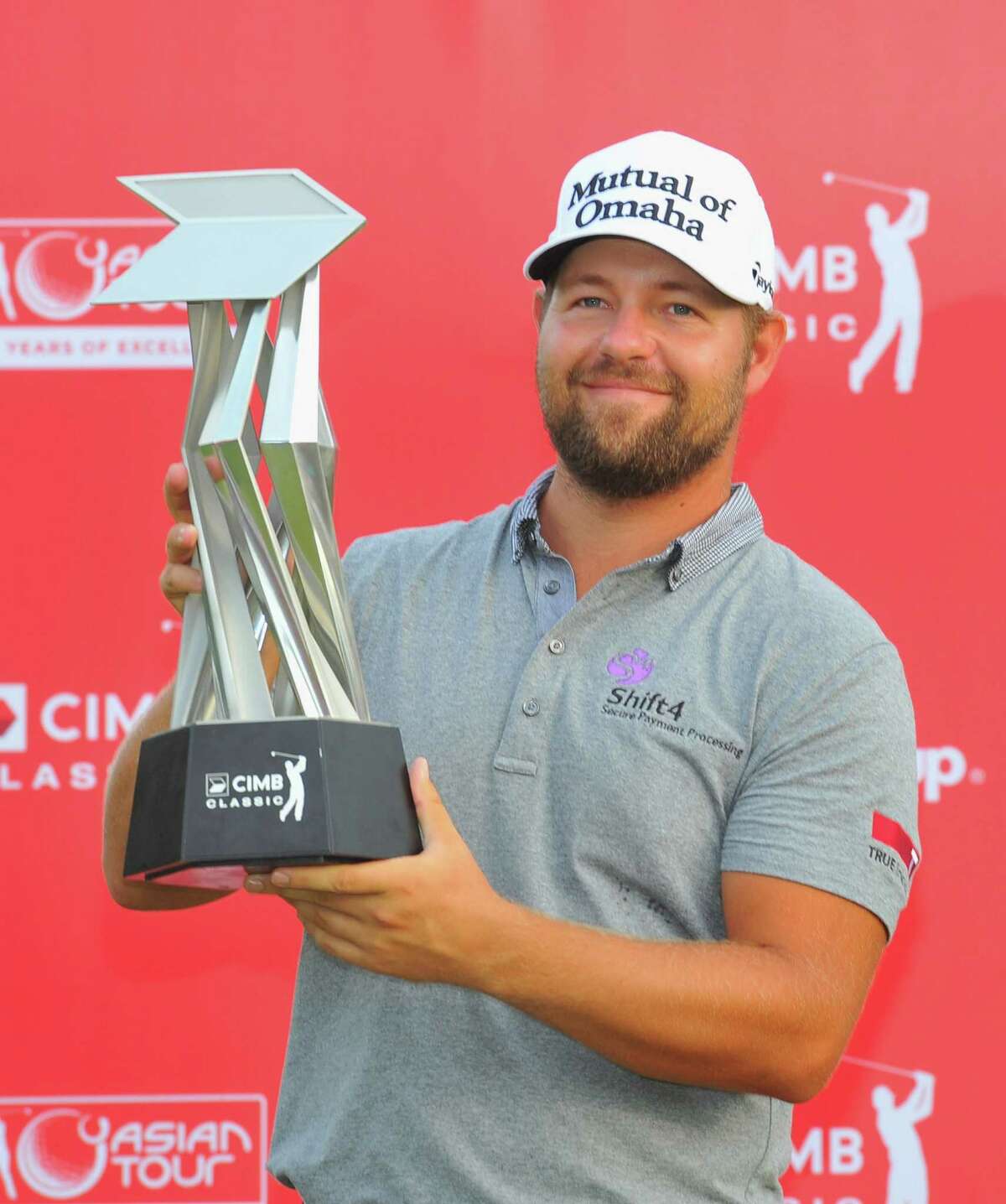 KUALA LUMPUR, MALAYSIA - OCTOBER 28: Ryan Moore of the United States poses with the CIMB Classic Trophy after he won it in a playoff with Gary Woodland of the United States during the playoff during the CIMB Classic at Kuala Lumpur Golf & Country Club on October 28, 2013 in Kuala Lumpur, Malaysia. (Photo by Stanley Chou/Getty Images)