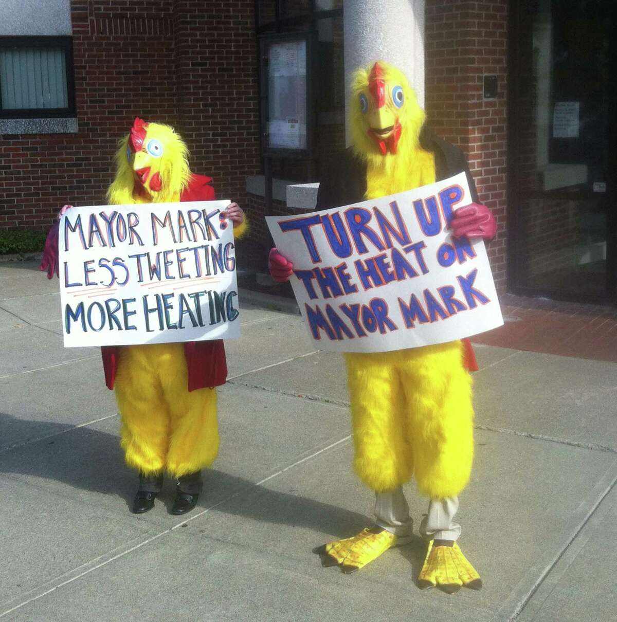 Two people dressed up as chickens were sent to City Hall by state Democrats Tuesday to poke fun at a Twitter exchange between Mayor Mark Boughton and a high school student who had complained about a lack of heat at the school.