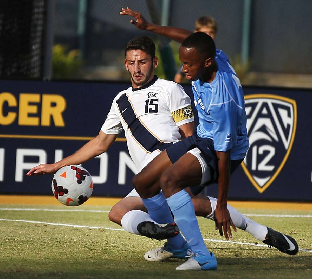 Cal's Steve Birnbaum, left, slide tackles San Diego's Blake Milton while competing in a match against University of San Diego October 25, 2013 at Goldman Field at Edwards Stadium in Berkeley, Calif. San Diego won the game.