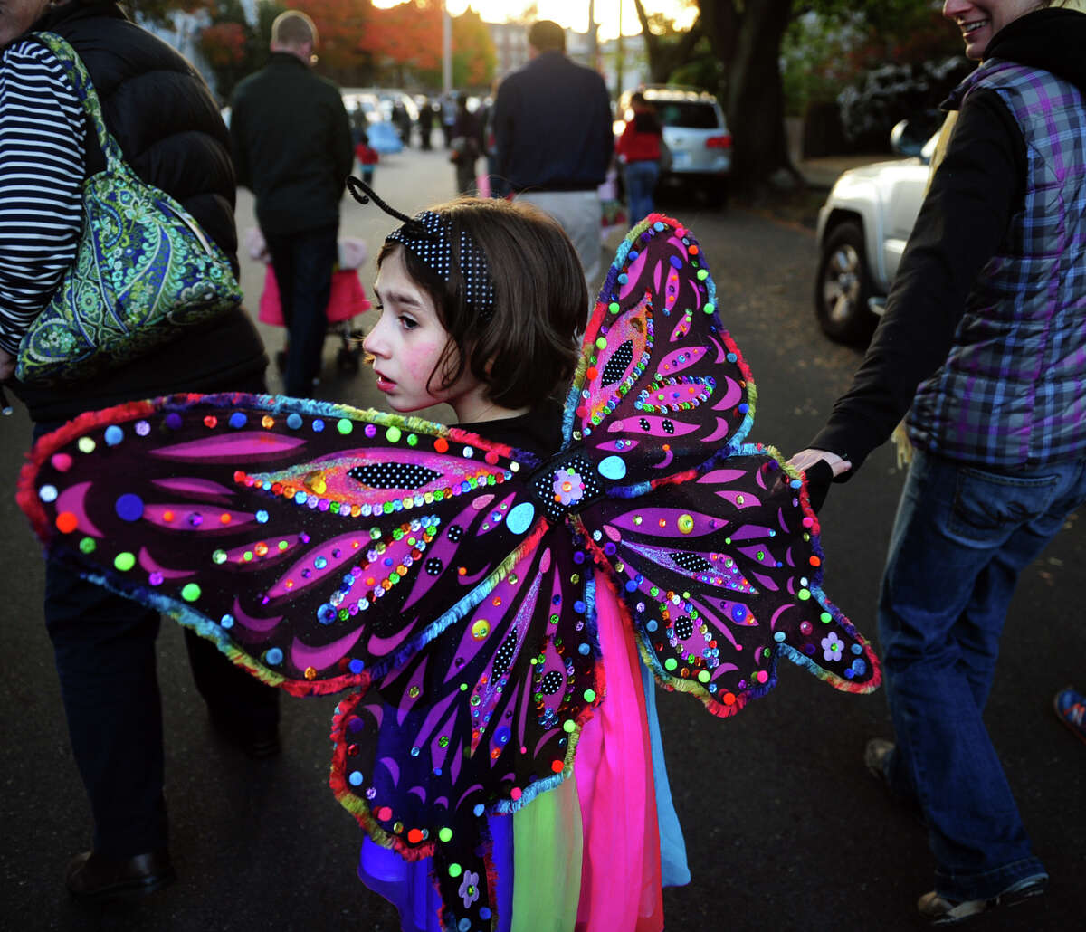 Rainbow butterfly Maggie Lupa, 6, of Bridgeport, floats along Tuesday, Oct. 29, 2013 during the 5th Annual Black Rock Halloween Parade & Block Party beginning at Ellsworth Park and ending at the Black Rock Branch Library.