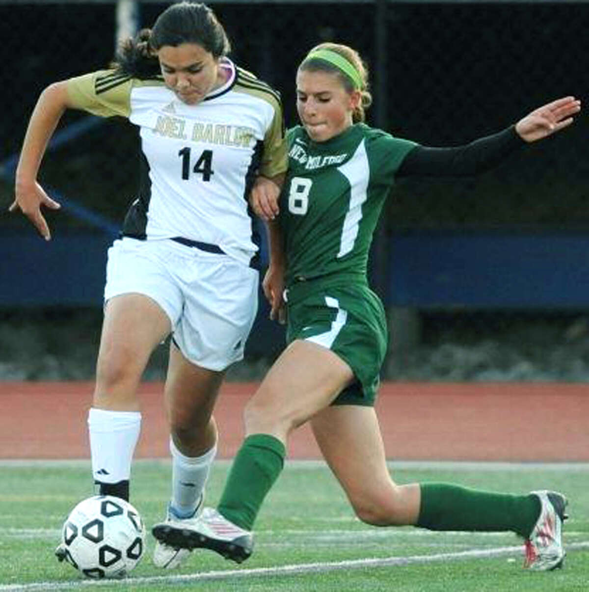 Saige Grazia (8) of the Green Wave beatrs a Falcon rival to the ball during New Milford High School girls' soccer's 1-0 victory over Joel Barlow in the South-West Conference playoff semifinals at Brookfield High. Oct.29, 2013 Photo by Tyler Sizemore
