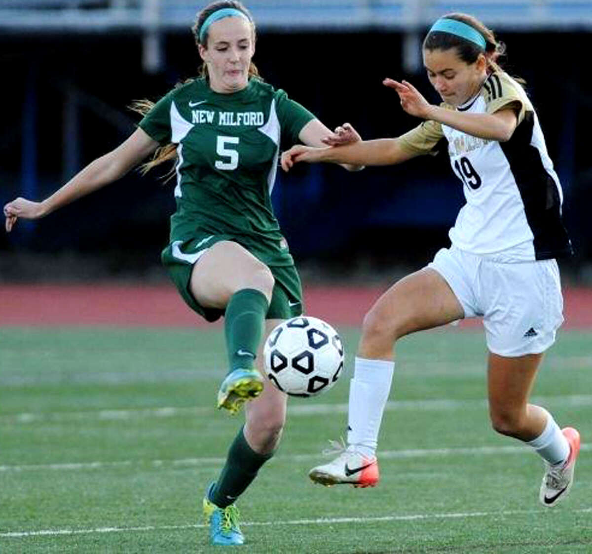 RachelWeir (5) of the Green Wave battles for possession during New Milford High School girls' soccer's 1-0 victory over Joel Barlow in the South-West Conference playoff semifinals at Brookfield High. Oct.29, 2013Photo by Tyler Sizemore