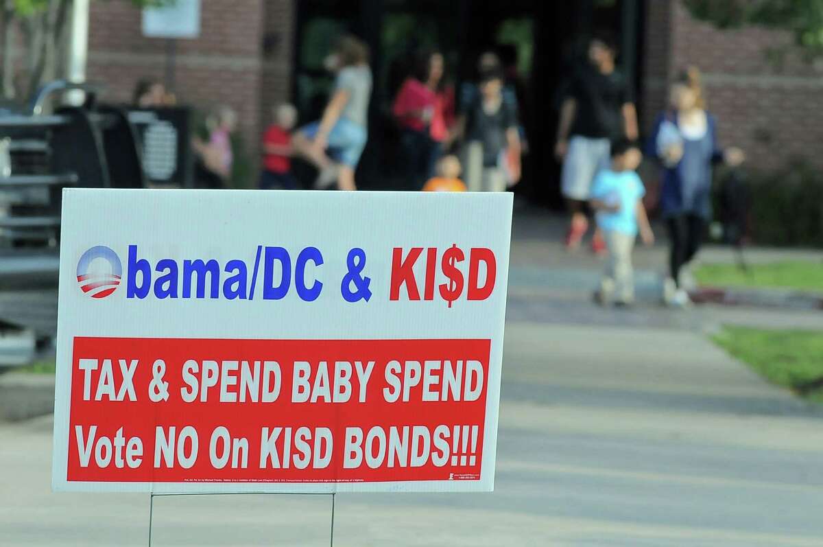 Election signs near the Cinco Ranch Library in Katy spell out the opposition's view of the stadium bond plan.