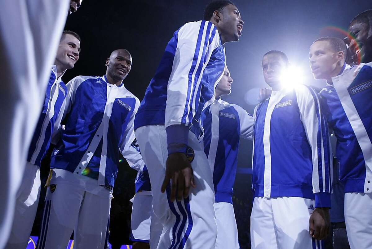 Warriors players get pumped up as they are introduced before the start of the game as the Golden State Warriors open their season against the Los Angeles Lakers at Oracle Arena in Oakland, CA Wednesday, October 30, 2013.