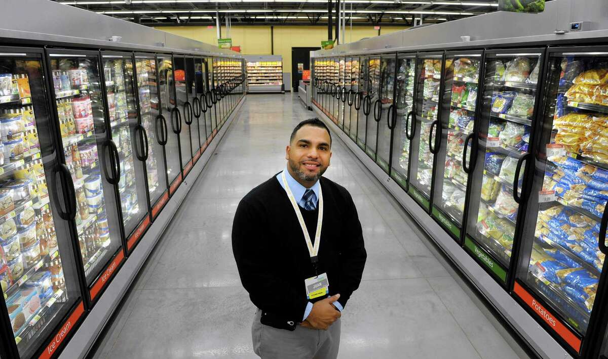 Store manager Juan Rivera stands in the frozen foods section at the Walmart Neighborhood Market on Thursday, Oct. 31, 2013 in Niskayuna, N.Y. The new grocery store opens Friday. (Paul Buckowski / Times Union)