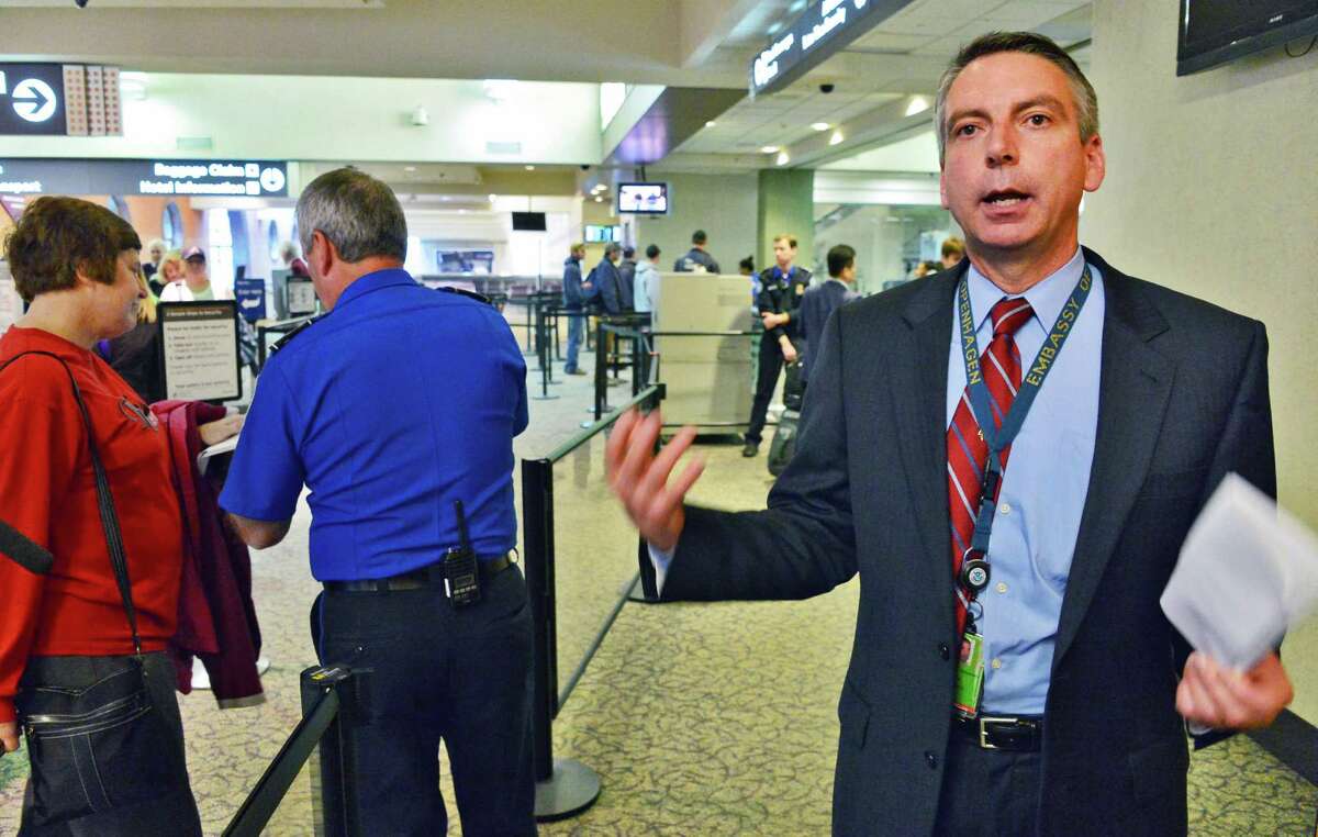 Brian Johansson, at right, Federal security director at Albany International Airport explains the TSA's new precheck line at the airport Thursday Oct. 31, 2013, in Colonie, NY. (John Carl D'Annibale / Times Union)