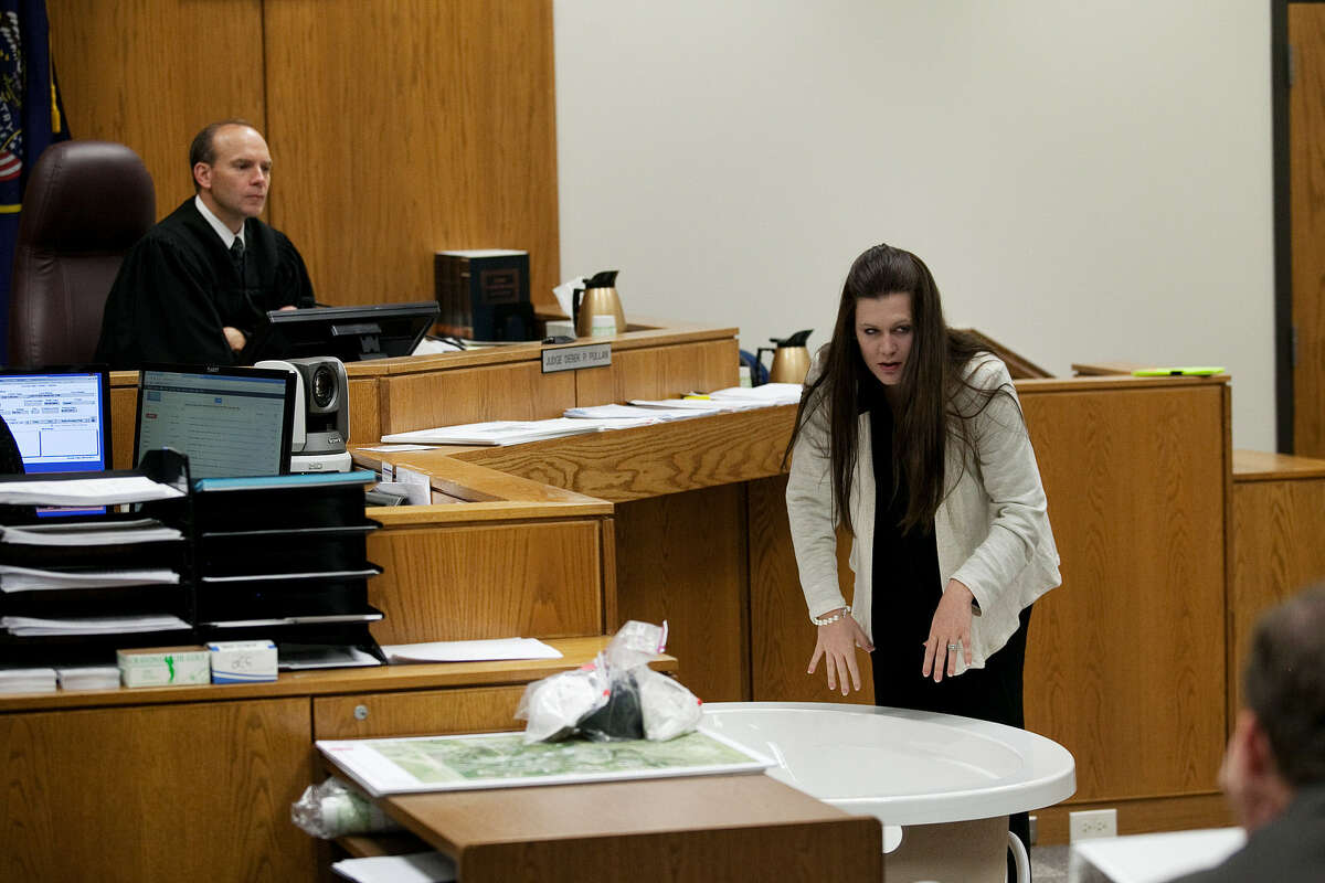 During testimony in Provo, Utah, Wednesday, Alexis Somers demonstrates the position in which her father, Martin MacNeill, told her he found his deceased wife.