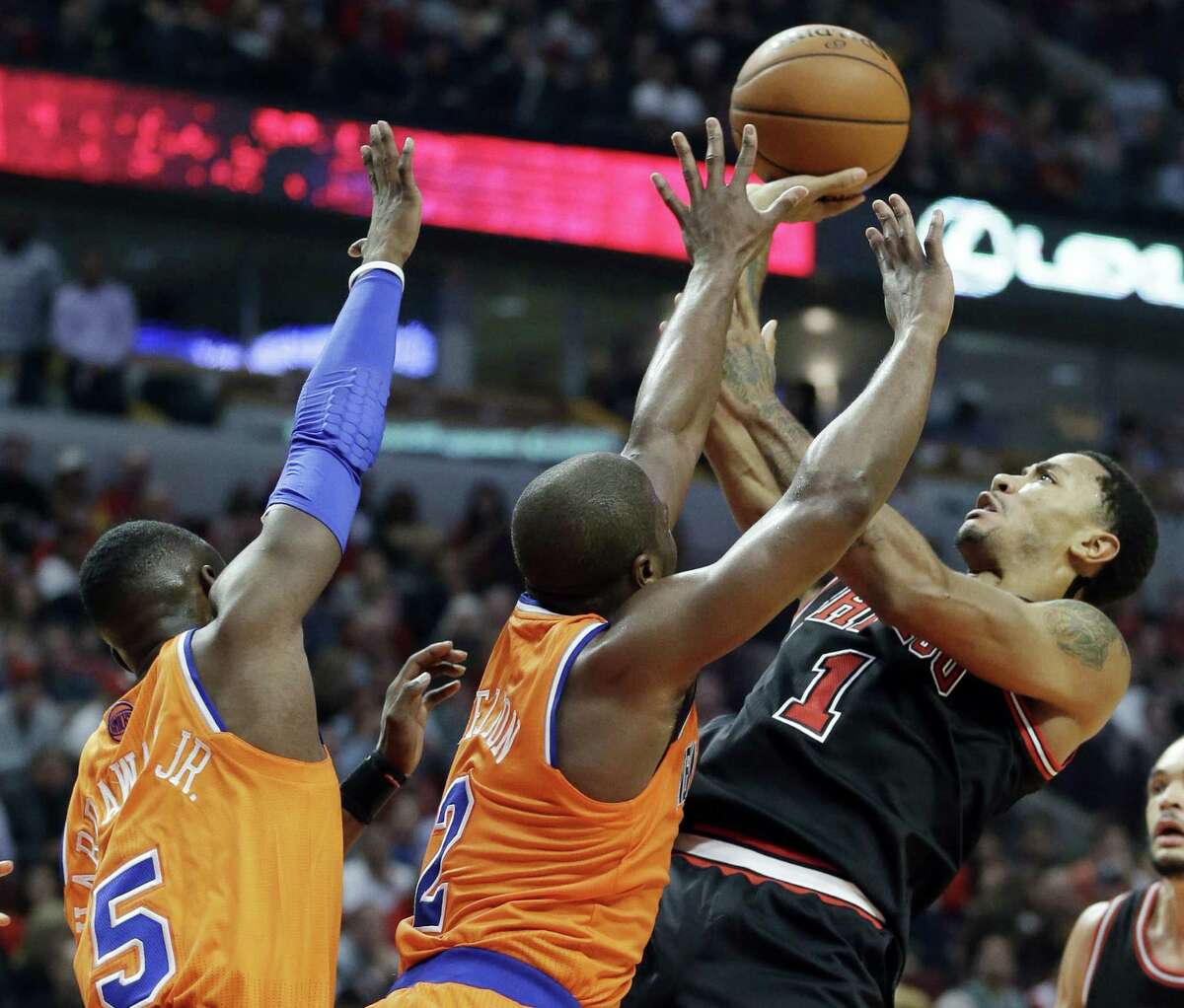 Bulls guard Derrick Rose (right) wore strips of black tape on either side of his sore neck in a game in which he shot 7 of 23 against New York.