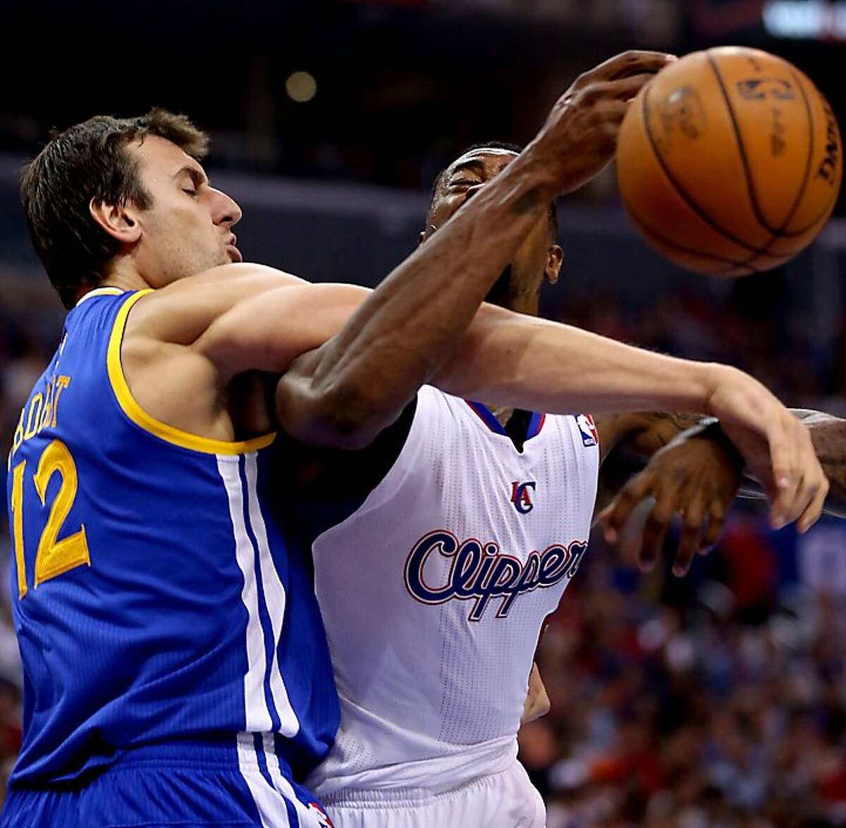 The Los Angeles Clippers' DeAndre Jordan, right, is fouled by the Golden State Warriors' Andrew Bogut, prompting an altercation in the first quarter at Staples Center in Los Angeles, California, on Thursday, October 31, 2013. (Luis Sinco/Los Angeles Times/MCT)