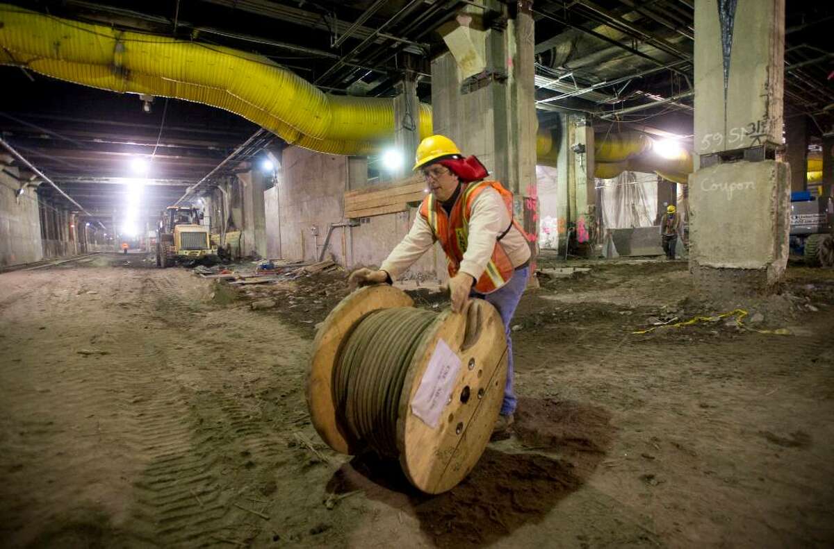 A worker rolls cable through what will become a new LIRR terminal under Grand Central during an MTA tour of the East Side Access Project, which will link the Long Island Rail Road to Grand Central Terminal in New York, on Thursday, Jan. 28, 2010.