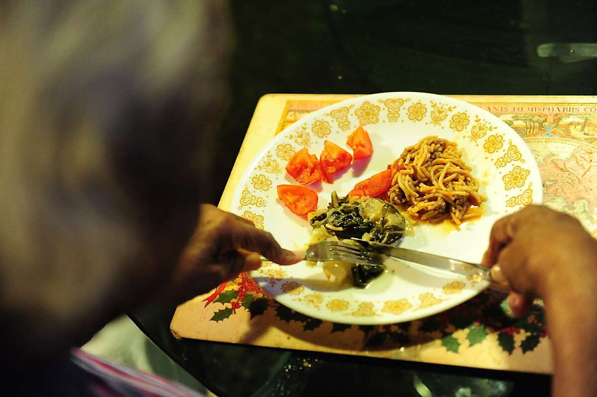 Essie Webb eats dinner at her home in San Francisco on October 31, 2013. Her family's food stamps, along with everyone else, will be cut tomorrow.
